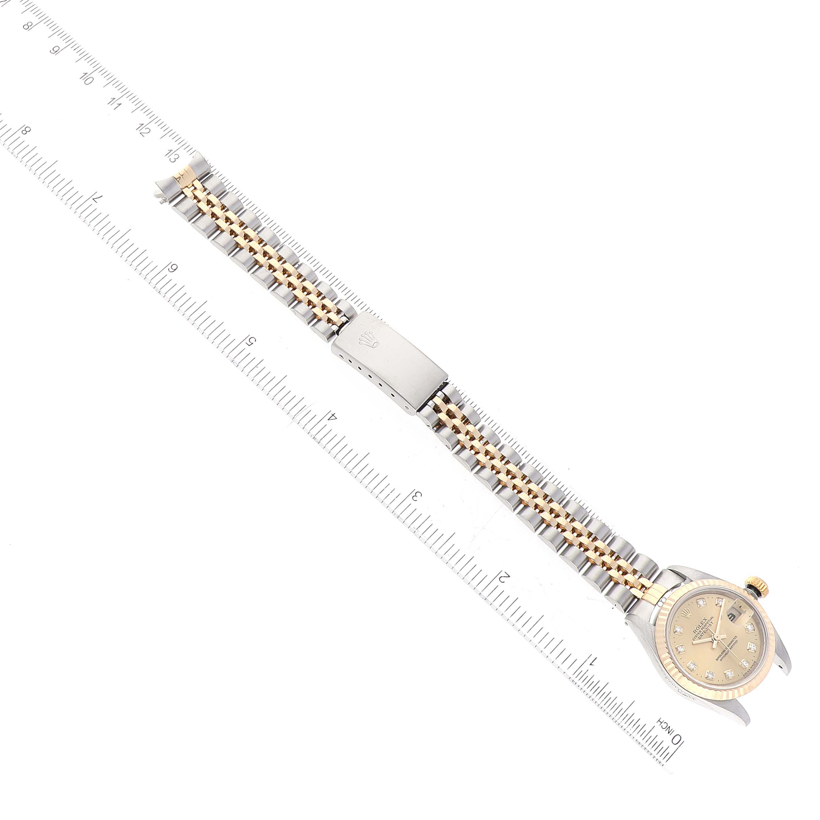 The image shows a Rolex Datejust 79173 Women's Steel and Gold (two tone) Champagne Dial 79173 Women's Steel and Gold (two tone) Champagne Dial model watch laid flat with its face and metal bracelet visible, aligned with a ruler.