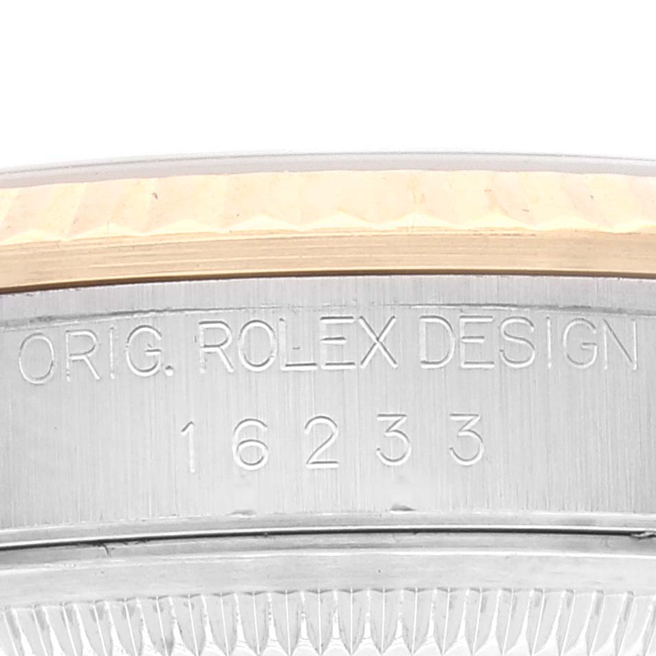 This image shows a close-up of the case side of a Rolex Datejust 16233 Men's Steel and Gold (two tone) Champagne Dial 16233 Men's Steel and Gold (two tone) Champagne Dial model, highlighting the engraved inscription and reference number.