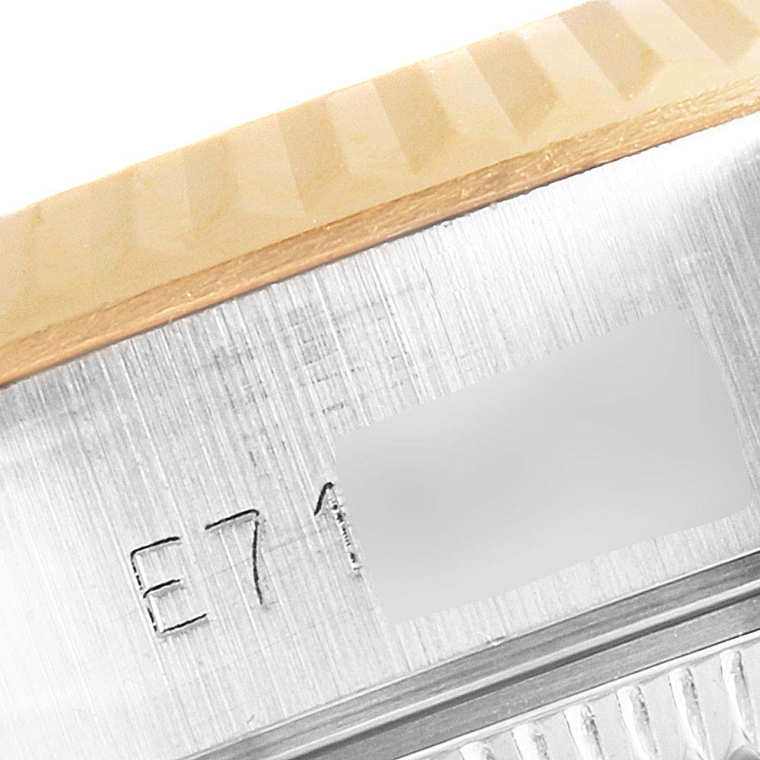 This image shows a close-up of the serial number engraved on the side of the case of a Rolex Datejust 69173 Women's Steel and Gold (two tone) Champagne Dial 69173 Women's Steel and Gold (two tone) Champagne Dial watch.