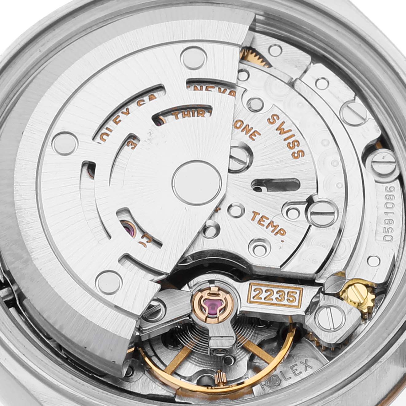 This image shows an internal view of the Rolex Datejust 79173 Women's Steel and Gold (two tone) Mother of Pearl Dial 79173 Women's Steel and Gold (two tone) Mother of Pearl Dial watch movement and mechanisms, focussing on the rotor and caliber 2235 markings.