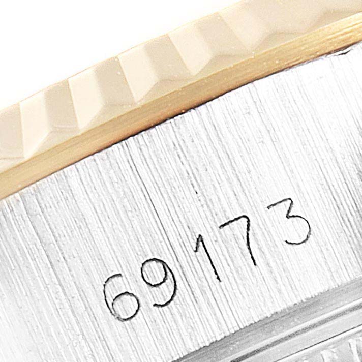 This image shows a close-up of the edge and part of the serial number of a Rolex Datejust 69173 Women
s Steel and Gold (two tone) Silver Dial 69173 Women
s Steel and Gold (two tone) Silver Dial model watch.