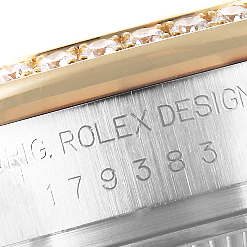 This close-up image of the Rolex Datejust 179383 Women
s Steel and Gold (two tone) Silver Dial 179383 Women
s Steel and Gold (two tone) Silver Dial watch shows part of the bezel with diamonds and the engraved model information.