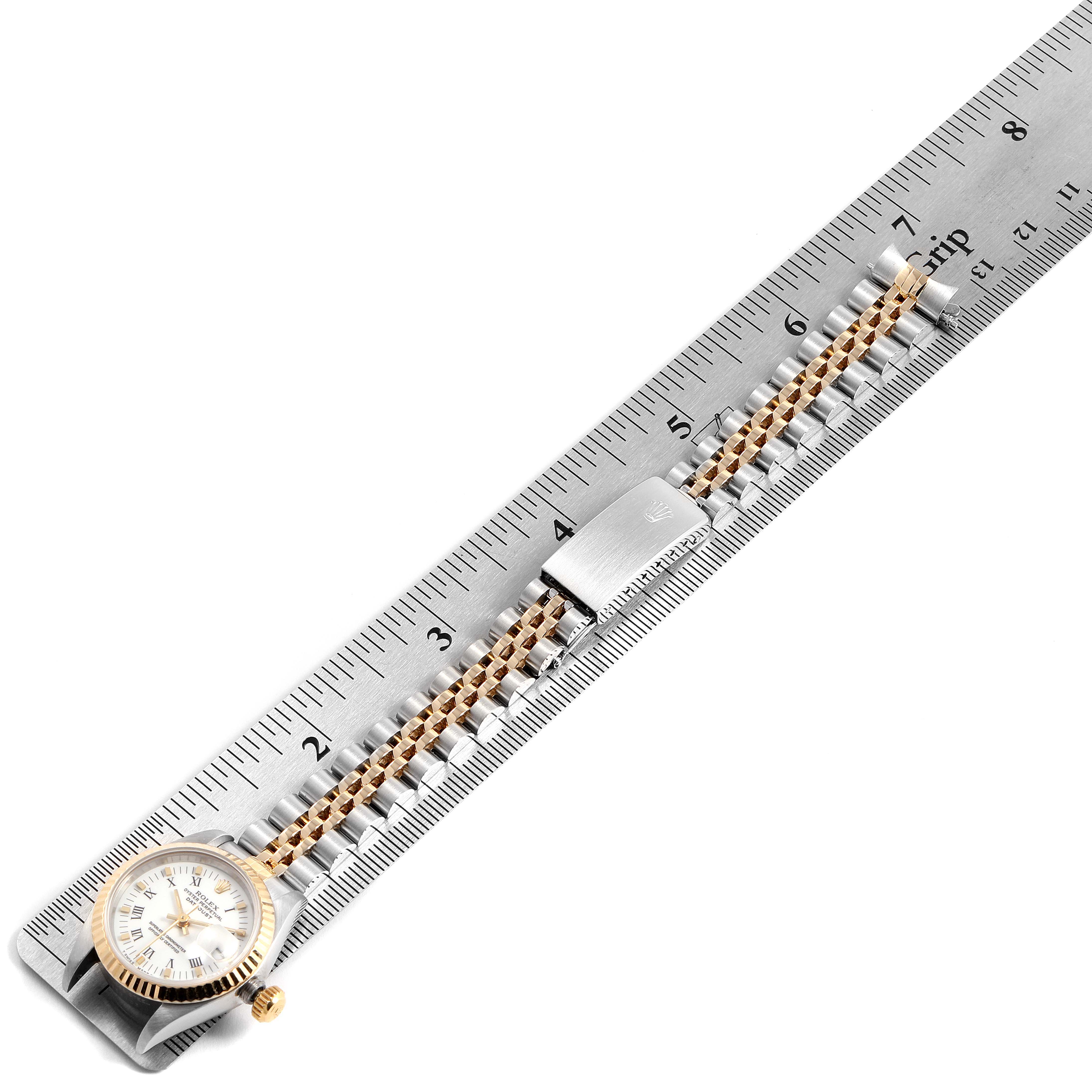 The Rolex Datejust 69173 Women's Steel and Gold (two tone) White Dial 69173 Women's Steel and Gold (two tone) White Dial watch is laid flat next to a ruler, showing the full length of the band and the face.