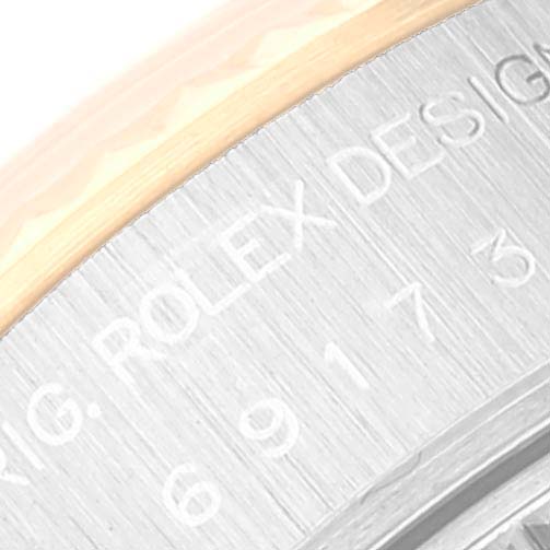 The image shows a close-up of the side of the case of a Rolex Datejust 69173 Women's Steel and Gold (two tone) White Dial 69173 Women's Steel and Gold (two tone) White Dial watch, highlighting the engraving.