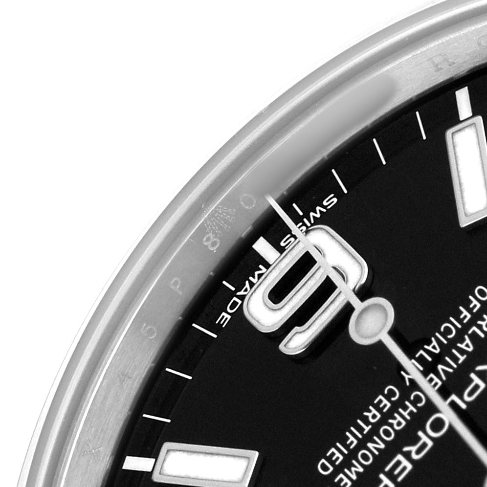 The image shows a close-up of the dial and bezel edge of the Rolex Explorer 214270 Men's Stainless Steel Black Dial, highlighting the "9" numeral and part of the minute hand.