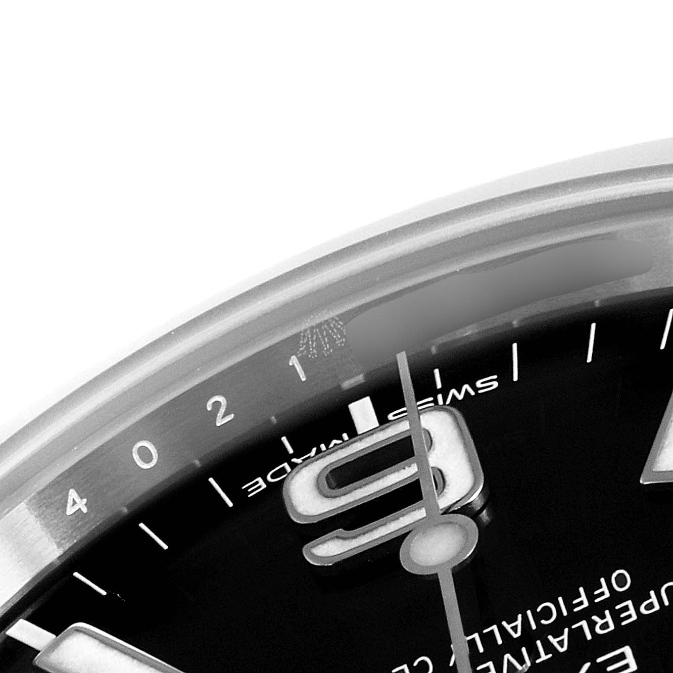 This image shows a close-up of the dial on a Rolex Explorer 214270 Men's Stainless Steel Black Dial 214270 Men's Stainless Steel Black Dial, highlighting the hour marker and part of the bezel.