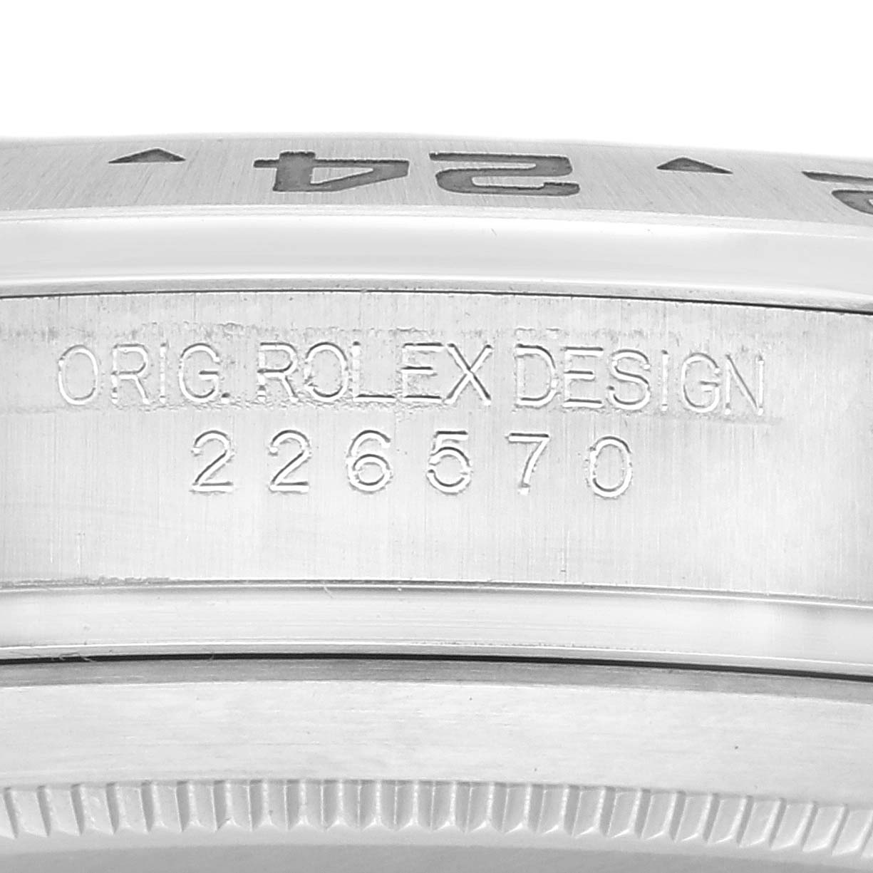 The image shows a close-up of the side of the bezel and case of the Rolex Explorer 226570 Men
s Stainless Steel White Dial 226570 Men
s Stainless Steel White Dial model, displaying the design engraving.