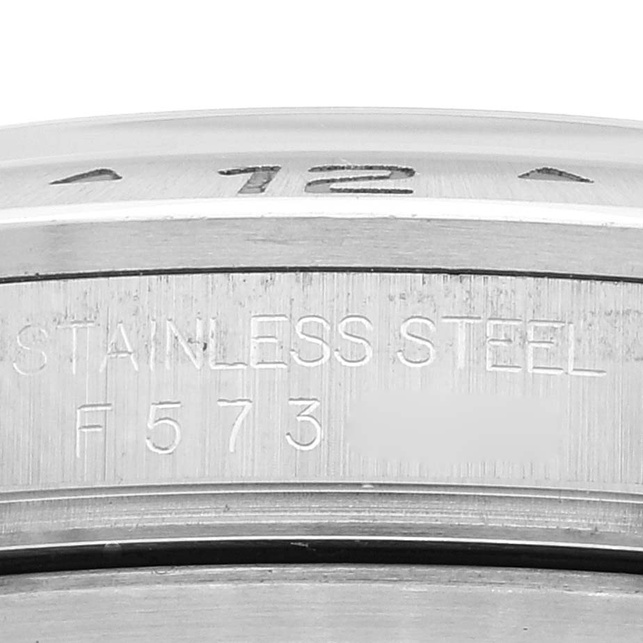 This image shows a close-up view of the side of a Rolex Explorer 16570 Men
s Stainless Steel Black Dial 16570 Men
s Stainless Steel Black Dial stainless steel bezel, displaying the inscriptions.