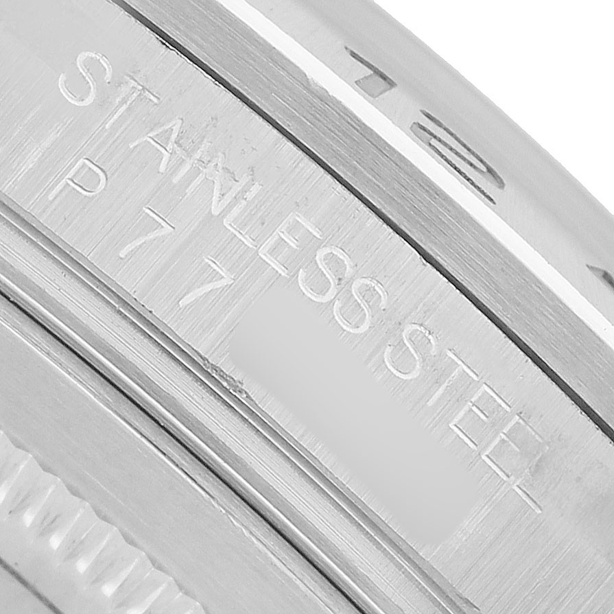 The image shows a close-up of the stainless steel casing with engraved details on a Rolex Explorer 16570 Men's Stainless Steel Black Dial watch.