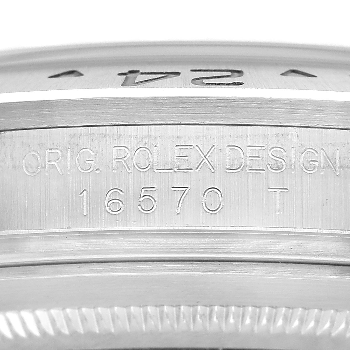 The image shows a close-up of the Rolex Explorer 16570 Men's Stainless Steel Black Dial model, highlighting the engraving on the inner case detailing the design and model number "16570 T".