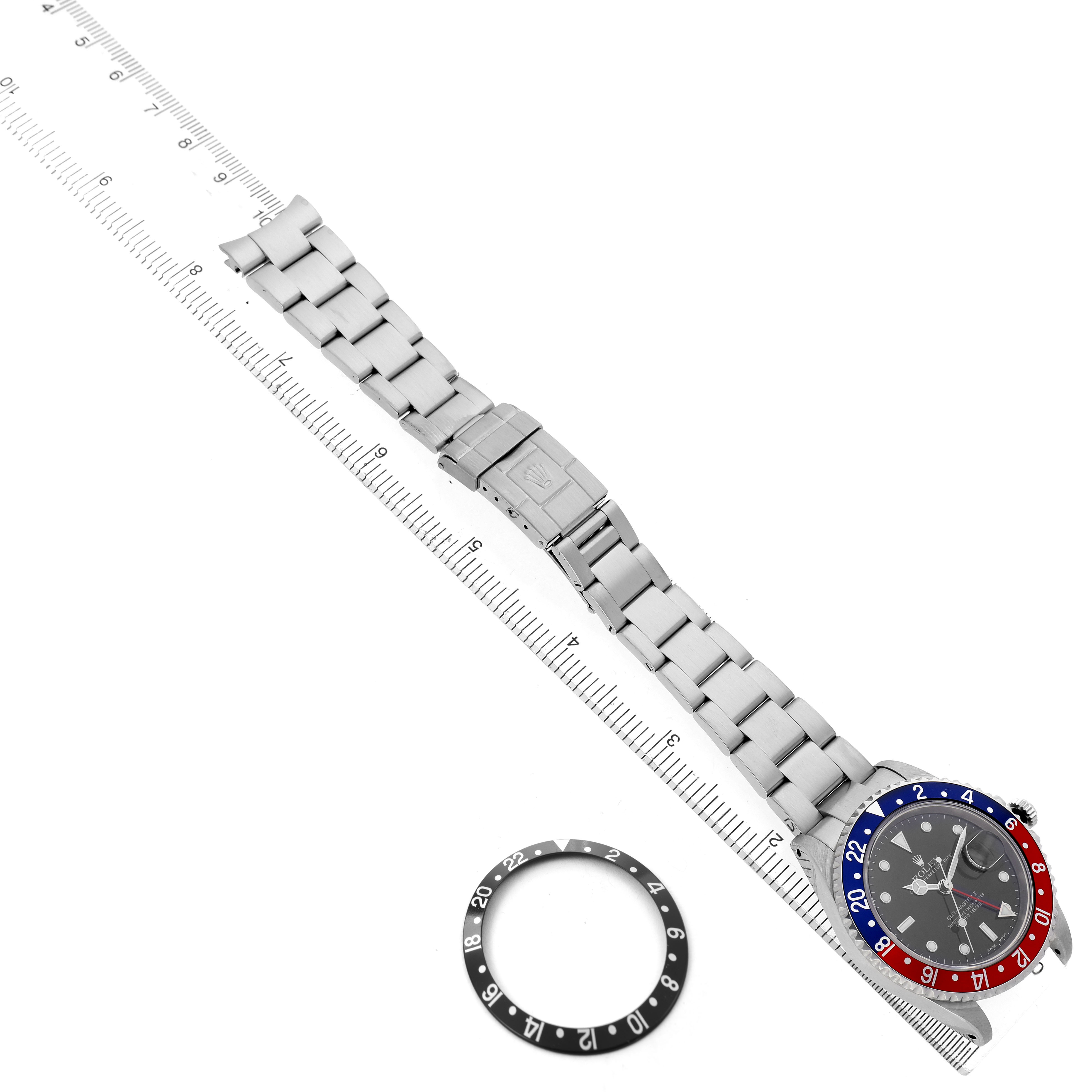The Rolex GMT-Master Men's Stainless Steel Black Dial watch is shown top view with a "Pepsi" bezel and a separate black bezel insert.