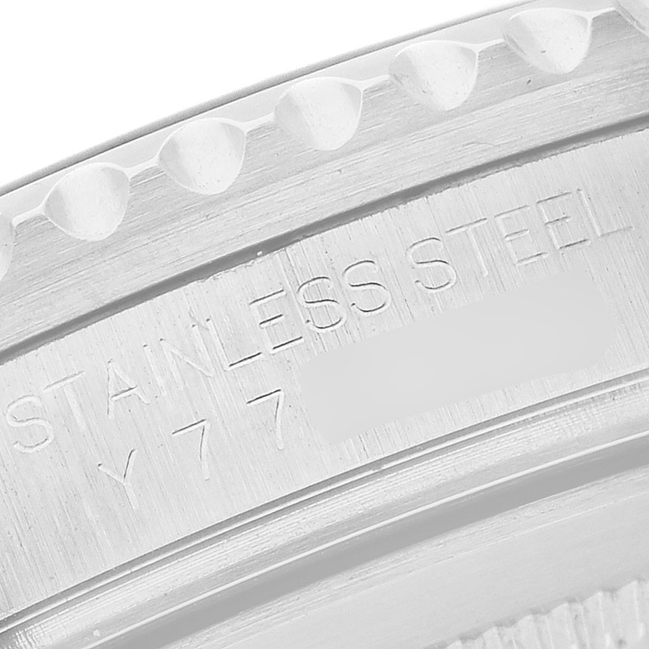 The image shows the edge and engraved markings on the bezel of a Rolex GMT-Master Men's Stainless Steel Black Dial watch.