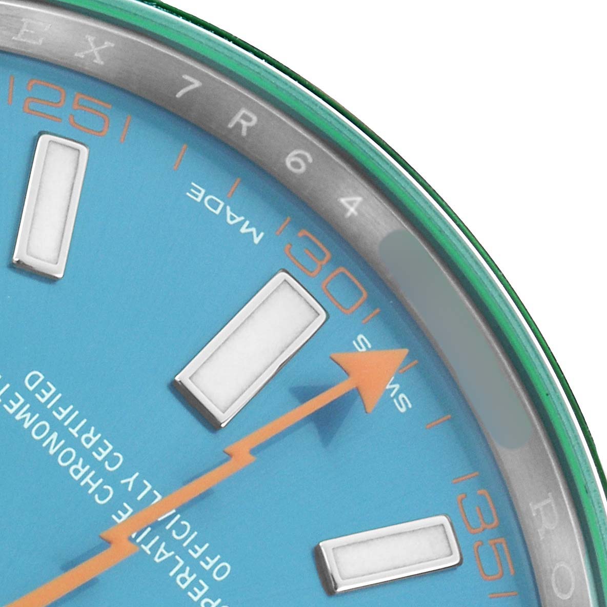 The image shows a close-up of the Rolex Milgauss 116400 Men's Stainless Steel Blue Dial dial, featuring blue surface, orange markers, and part of the distinctive green sapphire crystal.