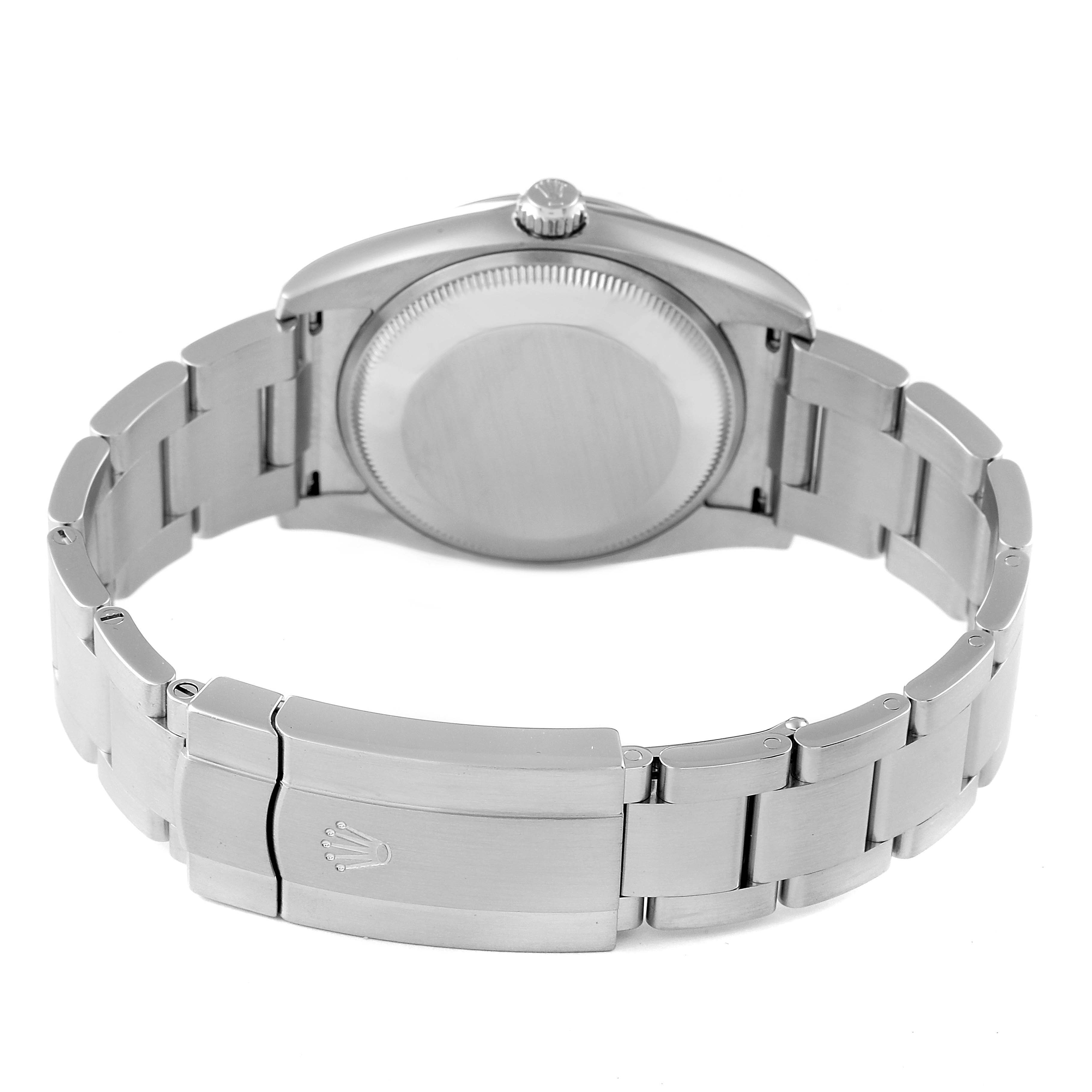 The image shows the back of a Rolex Oyster Perpetual 114200 Men's Stainless Steel Champagne Dial 114200 Men's Stainless Steel Champagne Dial watch, highlighting its case back and bracelet clasp.