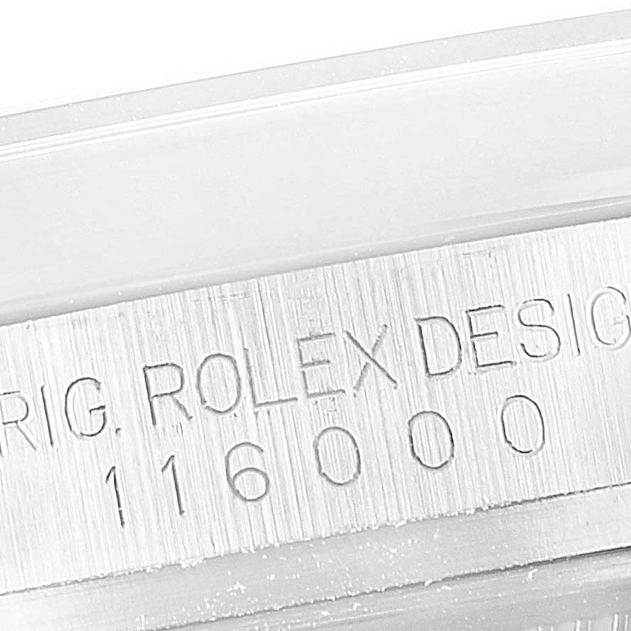 The image shows a close-up of the side of the casing on a Rolex Oyster Perpetual 116000 Men's Stainless Steel Champagne Dial 116000 Men's Stainless Steel Champagne Dial watch, engraved with "ROLEX DESIGN 116000".