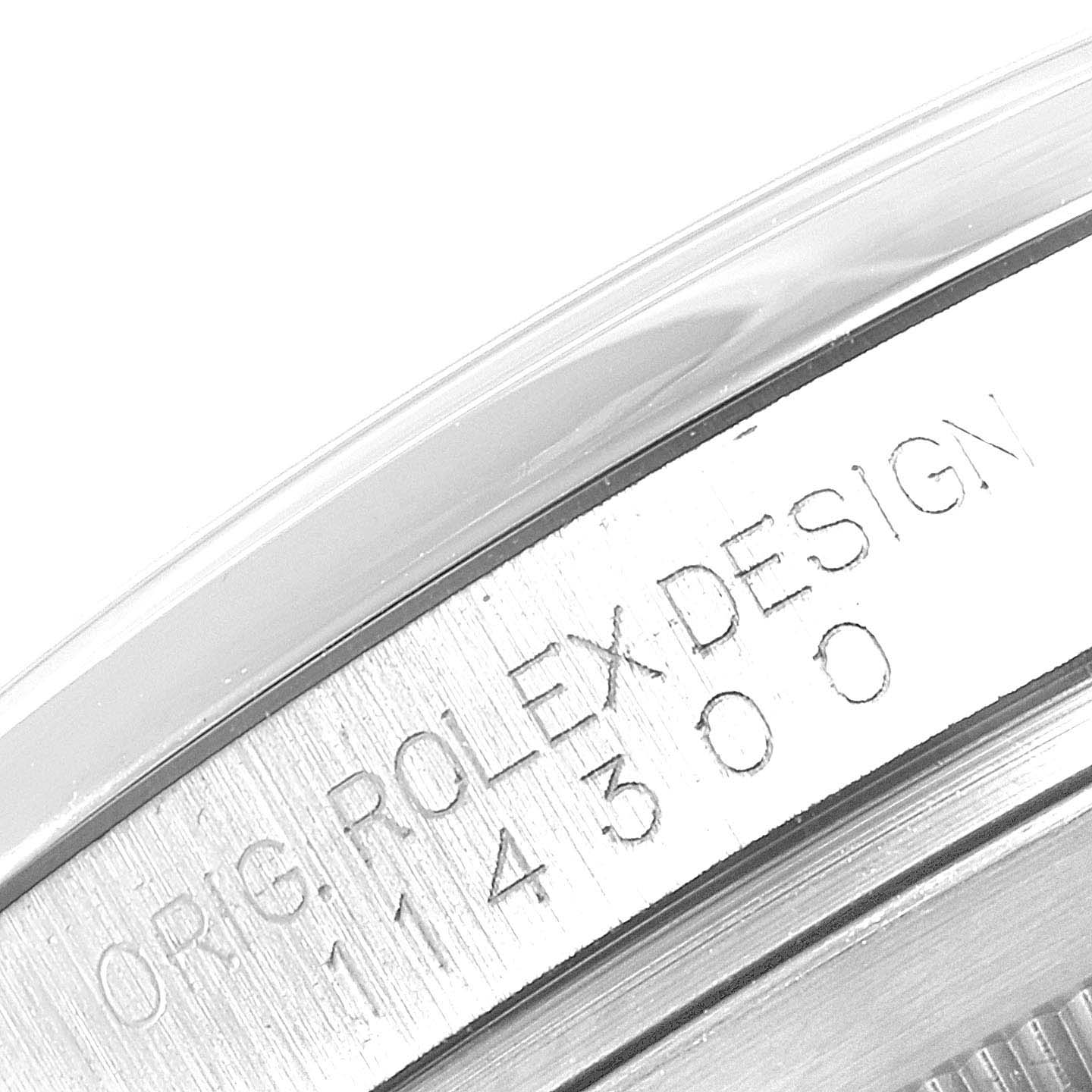 The image shows a close-up of the engravings on the side of a Rolex Oyster Perpetual 114300 Men
s Stainless Steel Black Dial 114300 Men
s Stainless Steel Black Dial watch case.