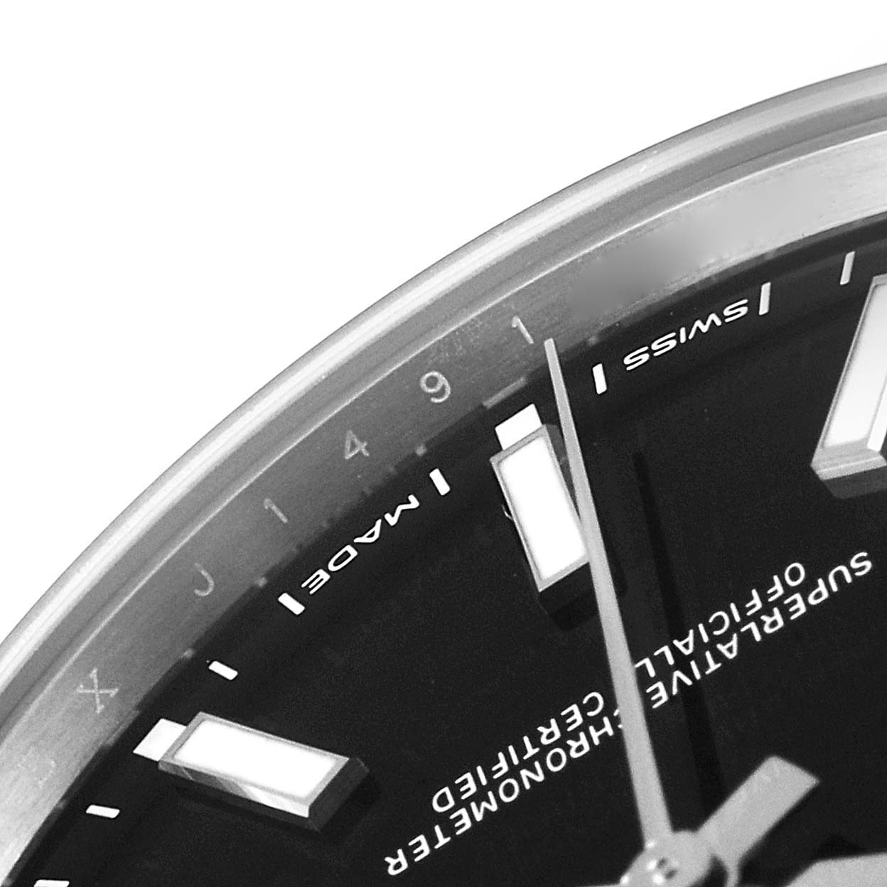 This image shows a close-up of the dial and hour markers of a Rolex Oyster Perpetual 114300 Men
s Stainless Steel Black Dial 114300 Men
s Stainless Steel Black Dial watch.