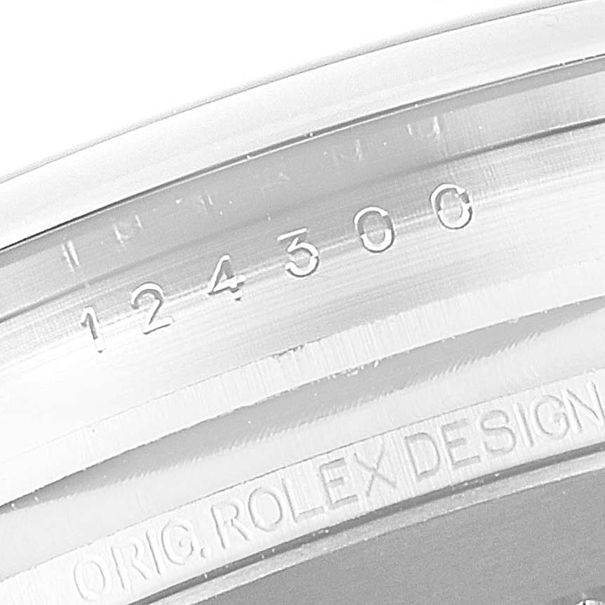 This image shows a close-up of the Rolex Oyster Perpetual 124300 Men
s Stainless Steel Black Dial 124300 Men
s Stainless Steel Black Dial watch, highlighting the serial number engraving on the case.