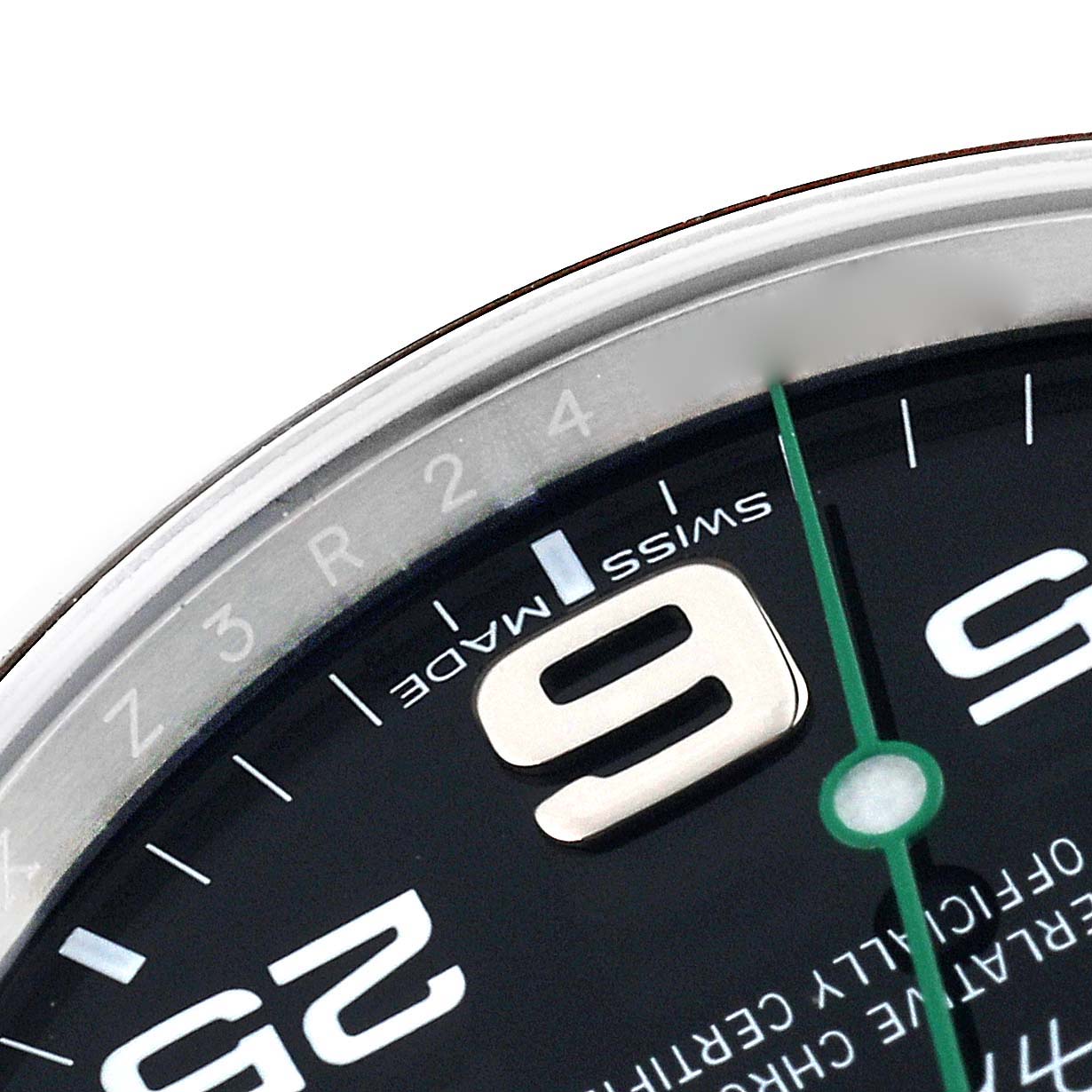 This close-up of the Rolex Air-King 116900 Men's Stainless Steel Black Dial 116900 Men's Stainless Steel Black Dial watch shows part of the dial with the numbers 9 and 5, the green seconds hand, and "Swiss Made" text.