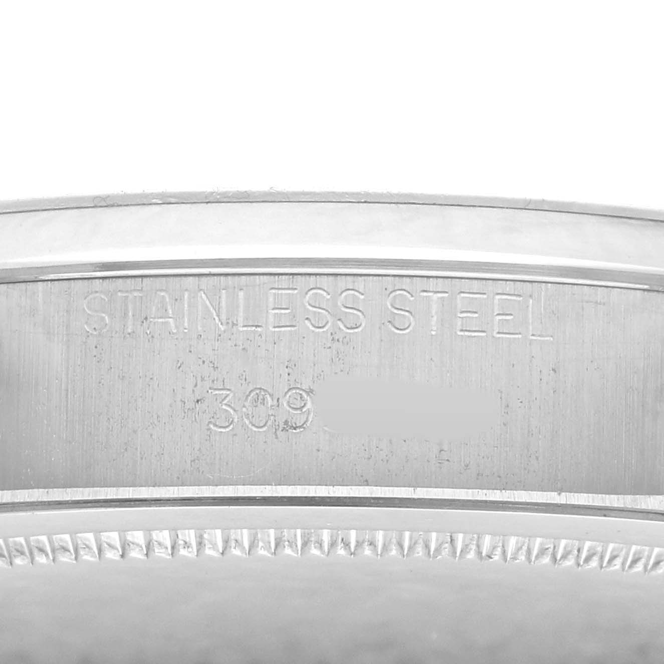 The image shows a close-up of the etched side of the stainless steel case of the Rolex Vintage Collection 6694 Men
s Stainless Steel Silver Dial watch.