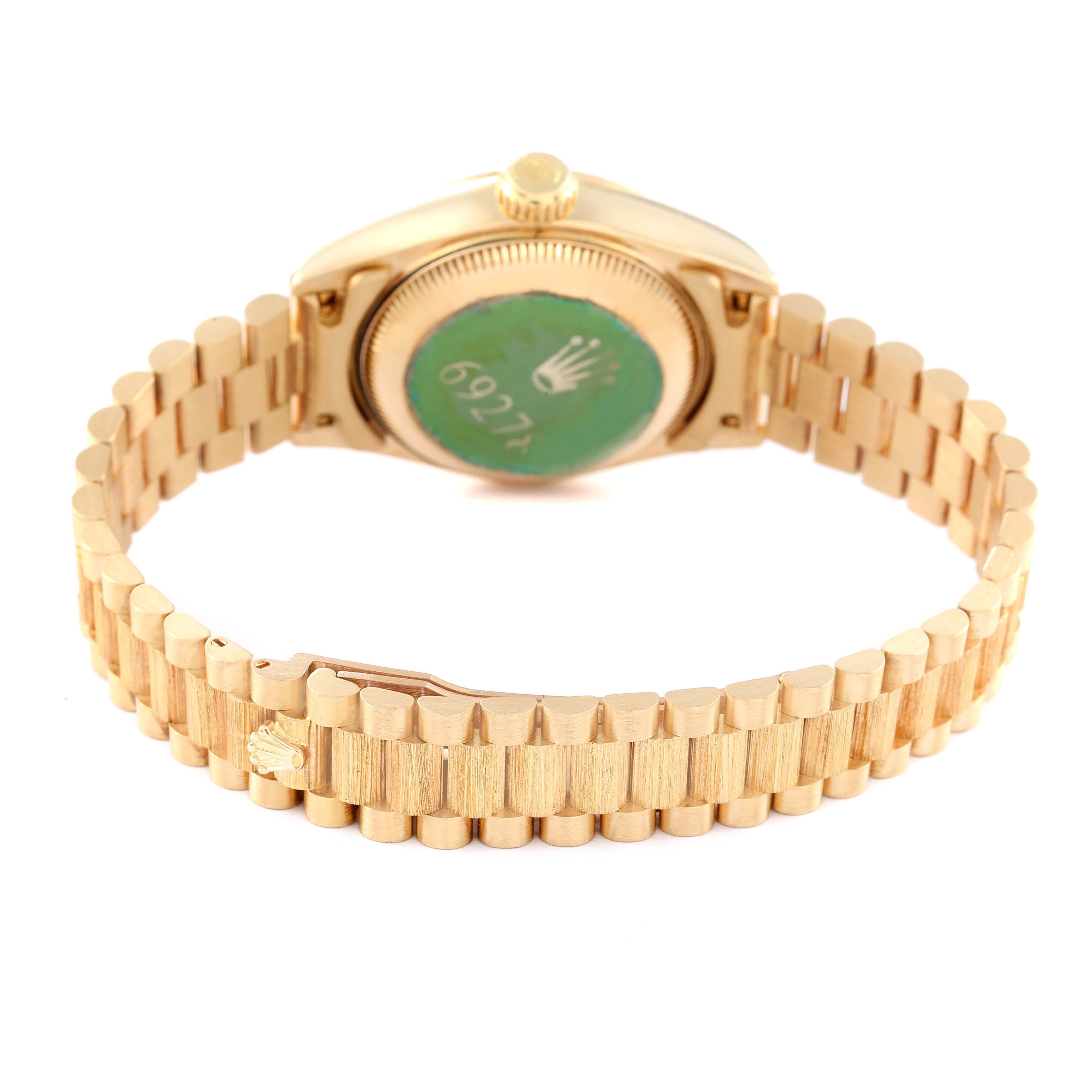 This image shows the back and bracelet of a Rolex President 69278 Women's Yellow Gold Beige Dial 69278 Women's Yellow Gold Beige Dial model watch, showcasing its gold finish and the green sticker on the case back.
