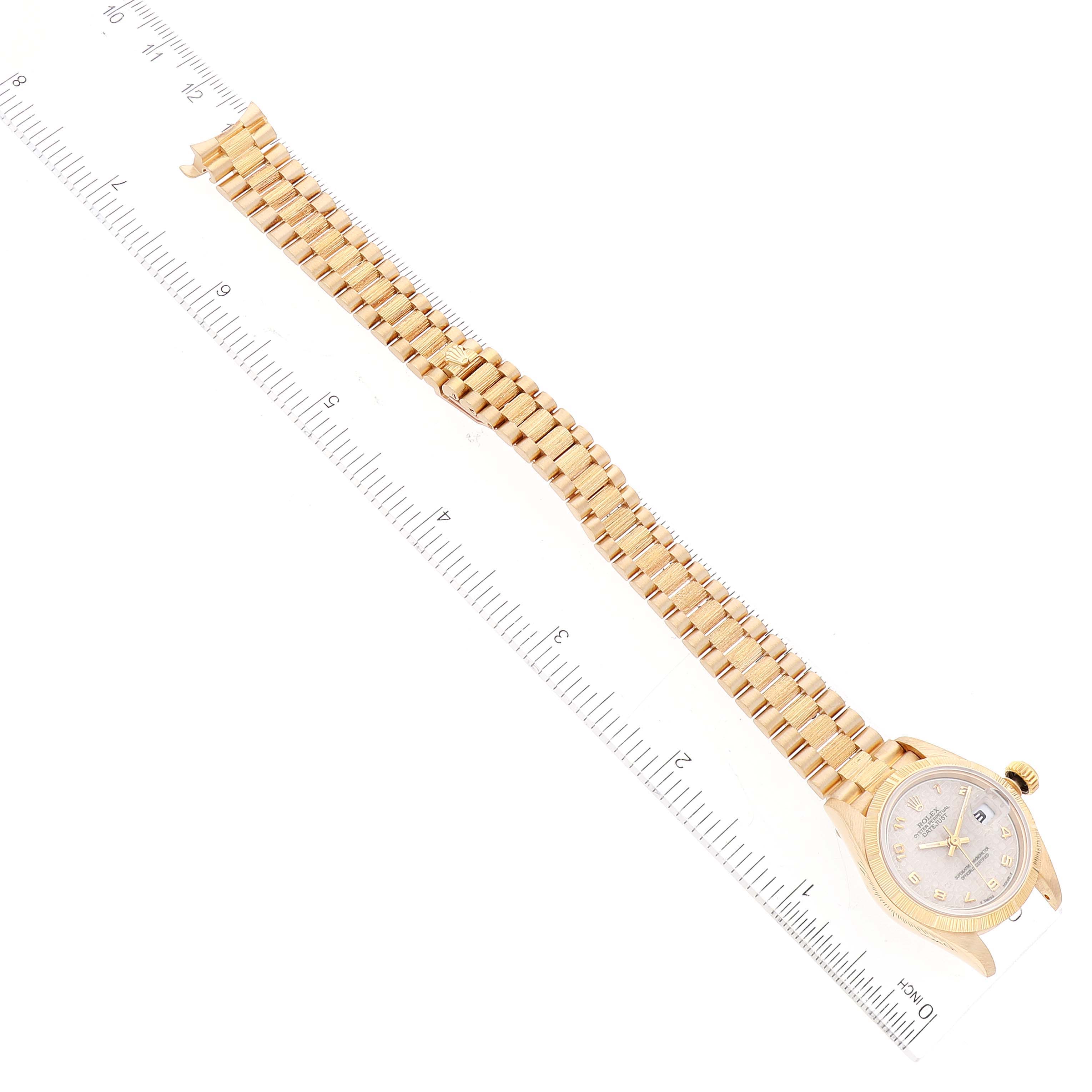 This image shows a Rolex President 69278 Women's Yellow Gold Beige Dial 69278 Women's Yellow Gold Beige Dial model watch, featuring its face and the entire strap, placed alongside a ruler for scale.