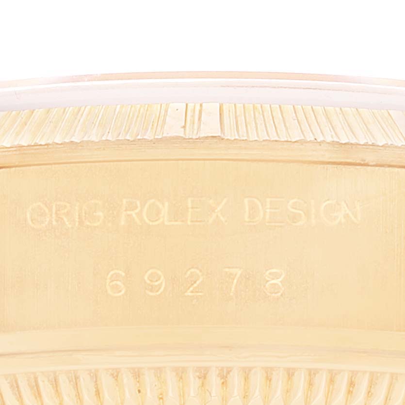 This is a close-up of the inner casing of a Rolex President 69278 Women's Yellow Gold Beige Dial 69278 Women's Yellow Gold Beige Dial model, showing the serial number and design engraving.
