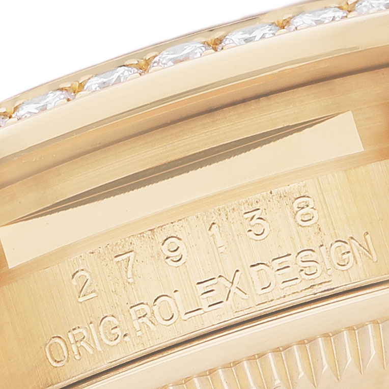 The image shows a close-up of the serial number and "ORIG. ROLEX DESIGN" engraving on a Rolex President 279138 Women's Yellow Gold Champagne Dial watch case.