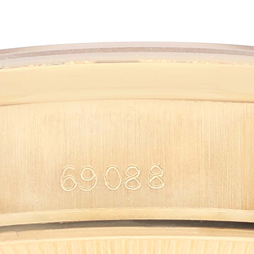 This image shows a close-up of the serial number inscribed on the gold case of a Rolex President 69088 Women
s Yellow Gold Champagne Dial 69088 Women
s Yellow Gold Champagne Dial model watch.