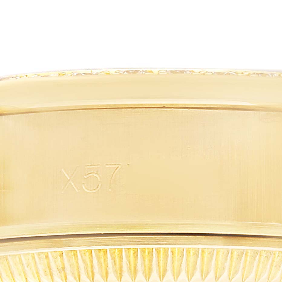 The image shows a close-up side view of the Rolex President 69158 Women
s Yellow Gold Champagne Dial model
s gold bezel and case with engravings.