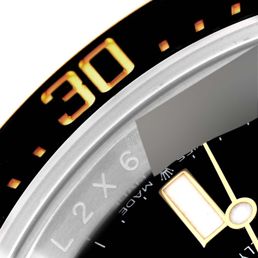 The image shows a close-up of the bezel and part of the dial of a Rolex Sea-Dweller 126603 Men
s Steel and Gold (two tone) Black Dial 126603 Men
s Steel and Gold (two tone) Black Dial watch.
