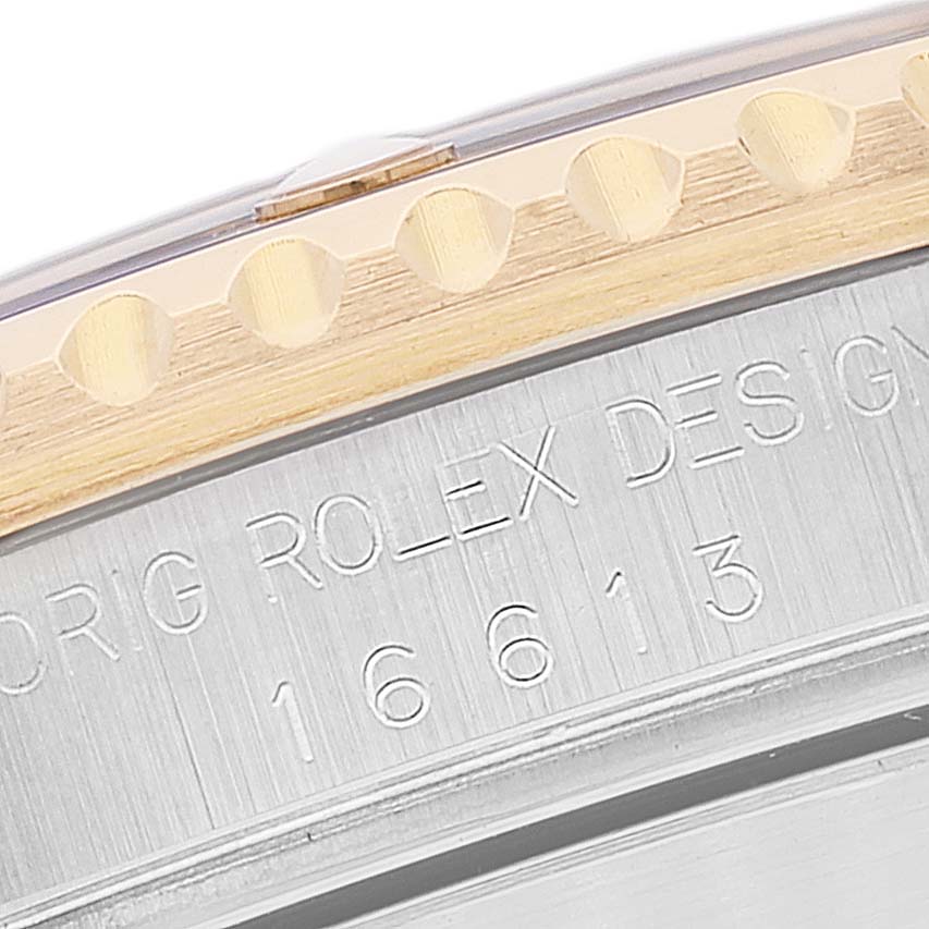 This image shows a close-up of the bezel and engraved model number (16613) on a Rolex Submariner 16613 Men
s Steel and Gold (two tone) Blue Dial 16613 Men
s Steel and Gold (two tone) Blue Dial watch.