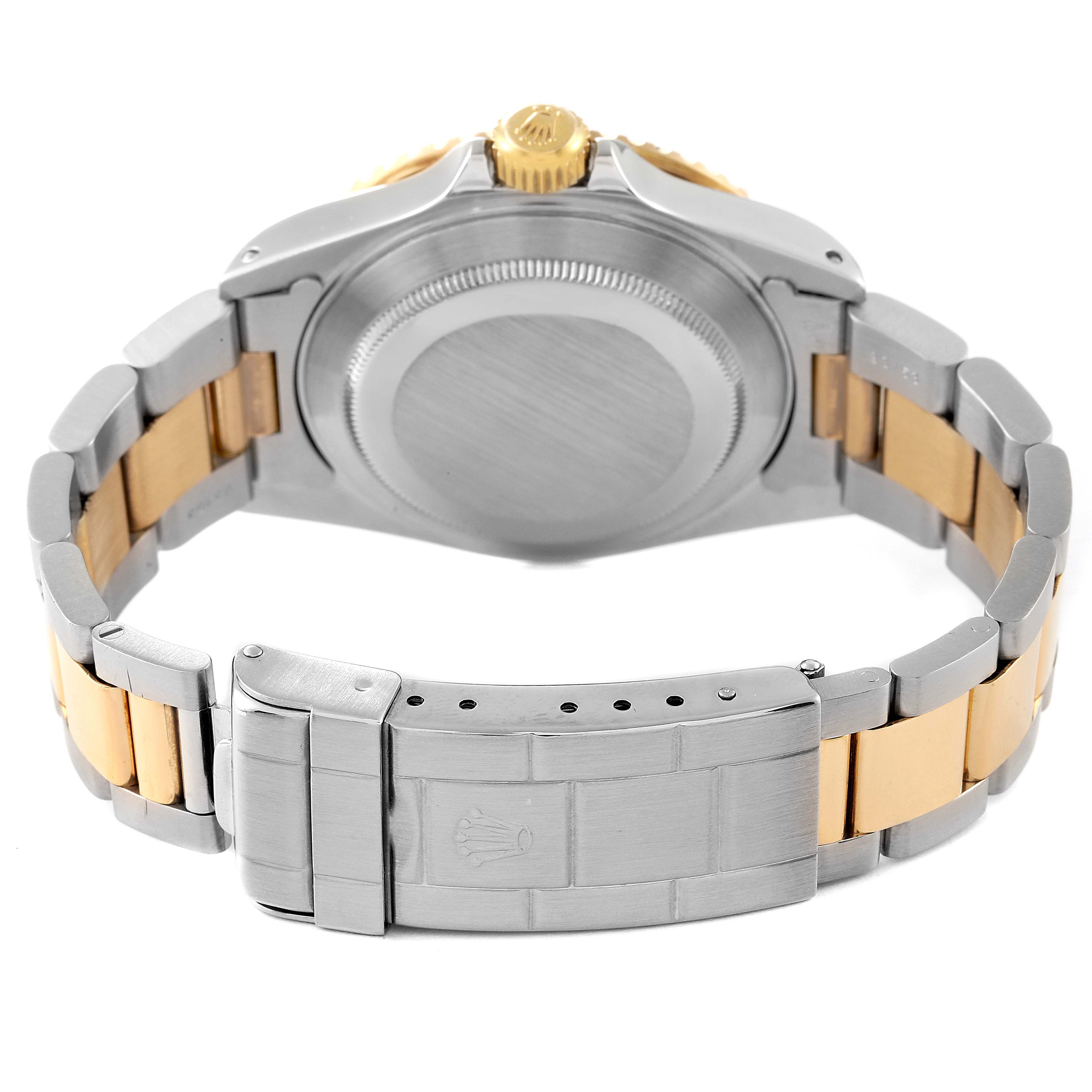 This image shows the underside and clasp of a Rolex Submariner 16613 Men
s Steel and Gold (two tone) Blue Dial 16613 Men
s Steel and Gold (two tone) Blue Dial watch, showcasing its bracelet and case back.