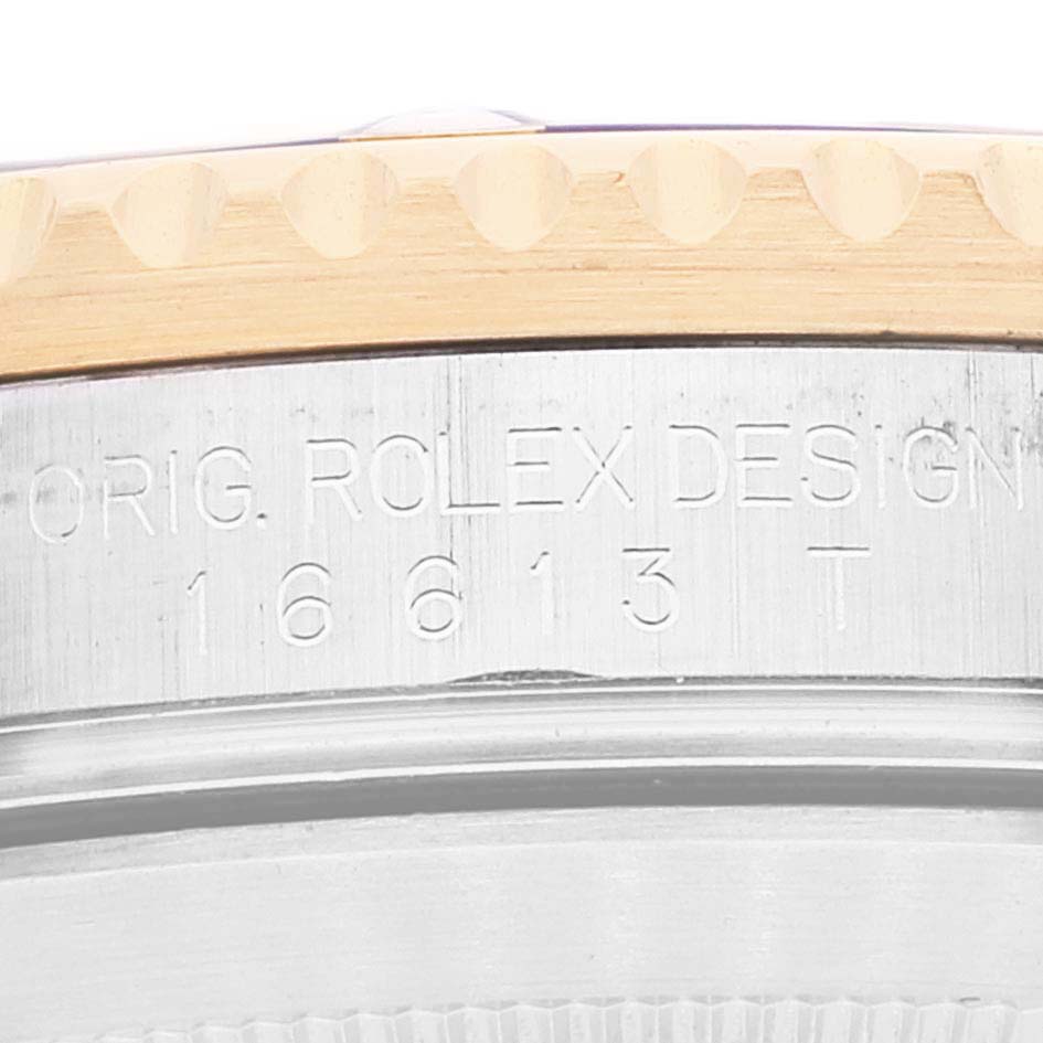 This close-up image of a Rolex Submariner 16613 Men
s Stainless Steel Blue Dial 16613 Men
s Stainless Steel Blue Dial watch shows the edge of the bezel and the engraved model number on the case side.