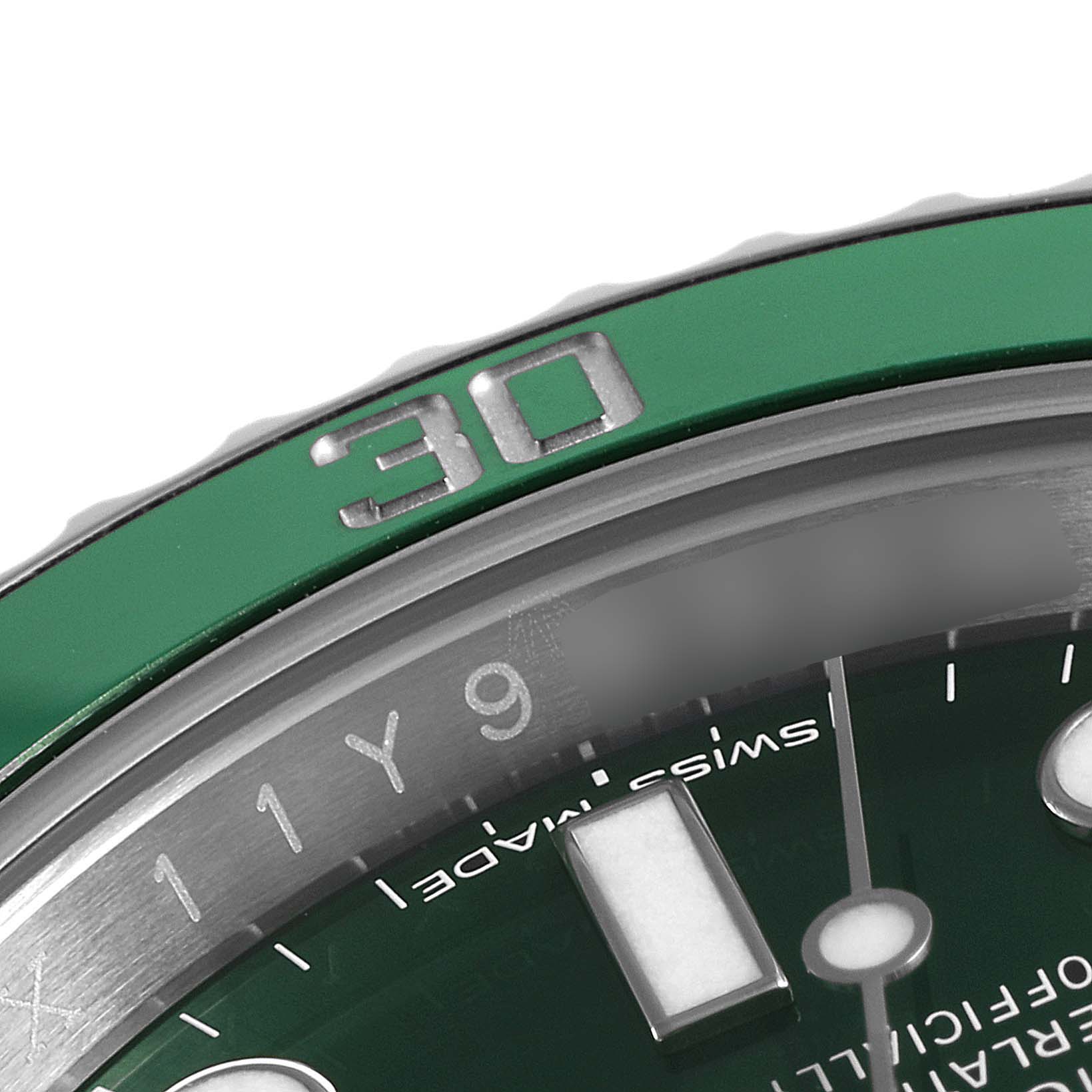 This close-up image of a Rolex Submariner 116610LV Men
s Stainless Steel Green Dial 116610LV Men
s Stainless Steel Green Dial watch shows a partial green bezel with the "30" mark and part of the dial with an hour marker.