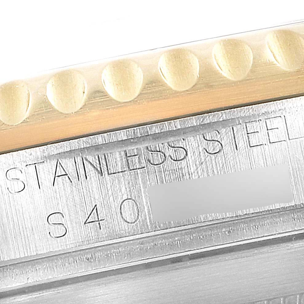 This close-up angle shows part of the stainless steel case and bezel of the Rolex Submariner 16613 Men's Steel and Gold (two tone) Black Dial 16613 Men's Steel and Gold (two tone) Black Dial watch.