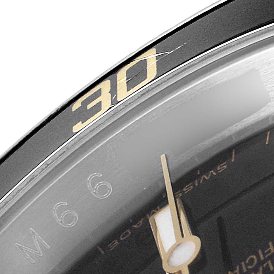 The image shows a close-up of the bezel and part of the dial of a Rolex Submariner 16613 Men's Steel and Gold (two tone) Black Dial 16613 Men's Steel and Gold (two tone) Black Dial watch, focusing on the 30-minute mark.