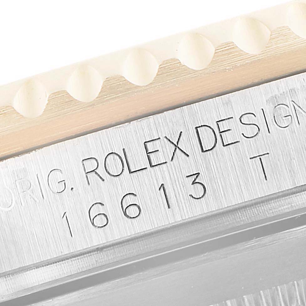 This image shows a close-up of the Rolex Submariner 16613 Men's Steel and Gold (two tone) Black Dial 16613 Men's Steel and Gold (two tone) Black Dial case with the model number 16613 engraved.