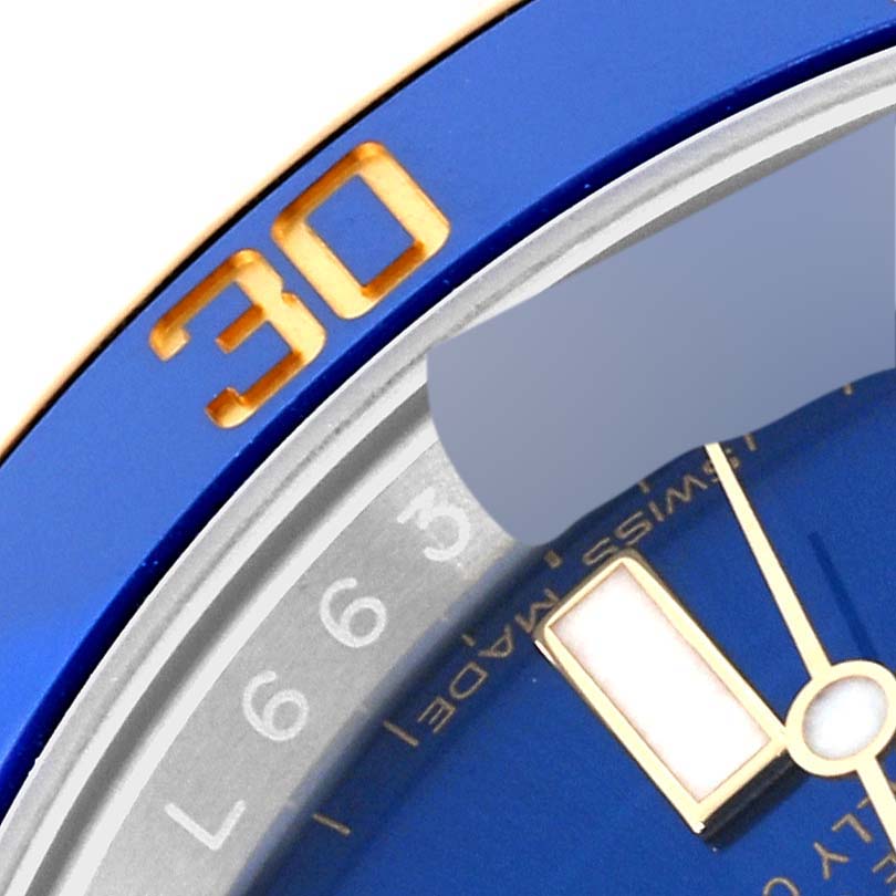 The image shows a close-up angle of the bezel and part of the dial of a Rolex Submariner 116613 Men's Steel and Gold (two tone) Blue Dial 116613 Men's Steel and Gold (two tone) Blue Dial watch, highlighting the 30-minute marker.