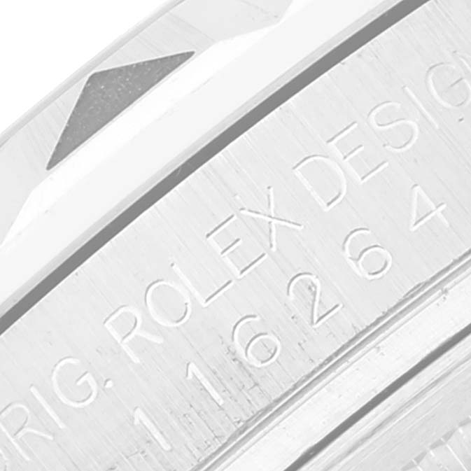The image shows a close-up of the engraved serial number and "Rolex Design" text on the Turn-o-Graph model by Rolex.