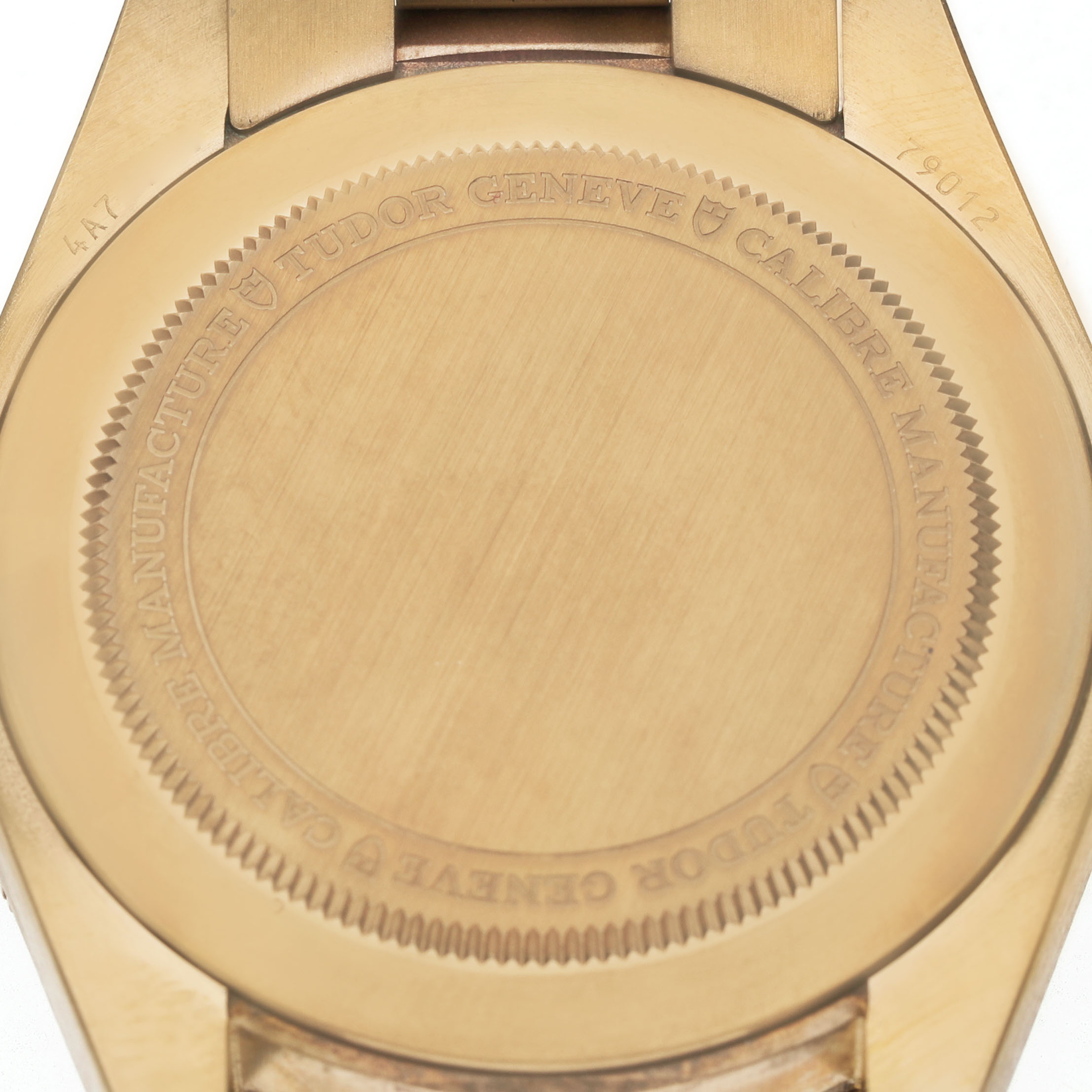 The image shows the back case of a Tudor Heritage Black Bay M79012M-0001 Men's Bronze Brown Dial watch, highlighting its engraved details.