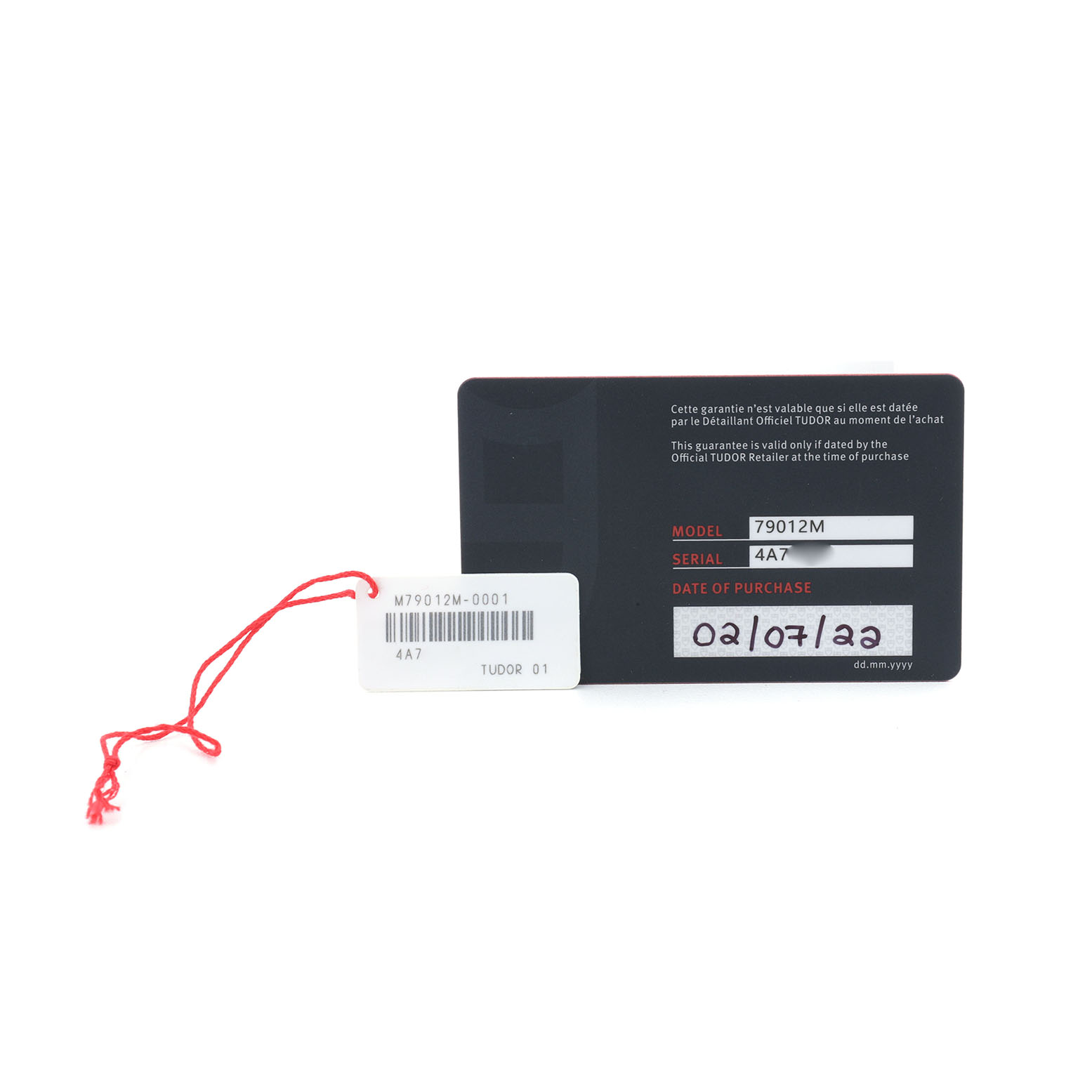 The image shows a warranty card and a tag for a Tudor Heritage Black Bay M79012M-0001 Men's Bronze Brown Dial watch, displaying the model and serial number.