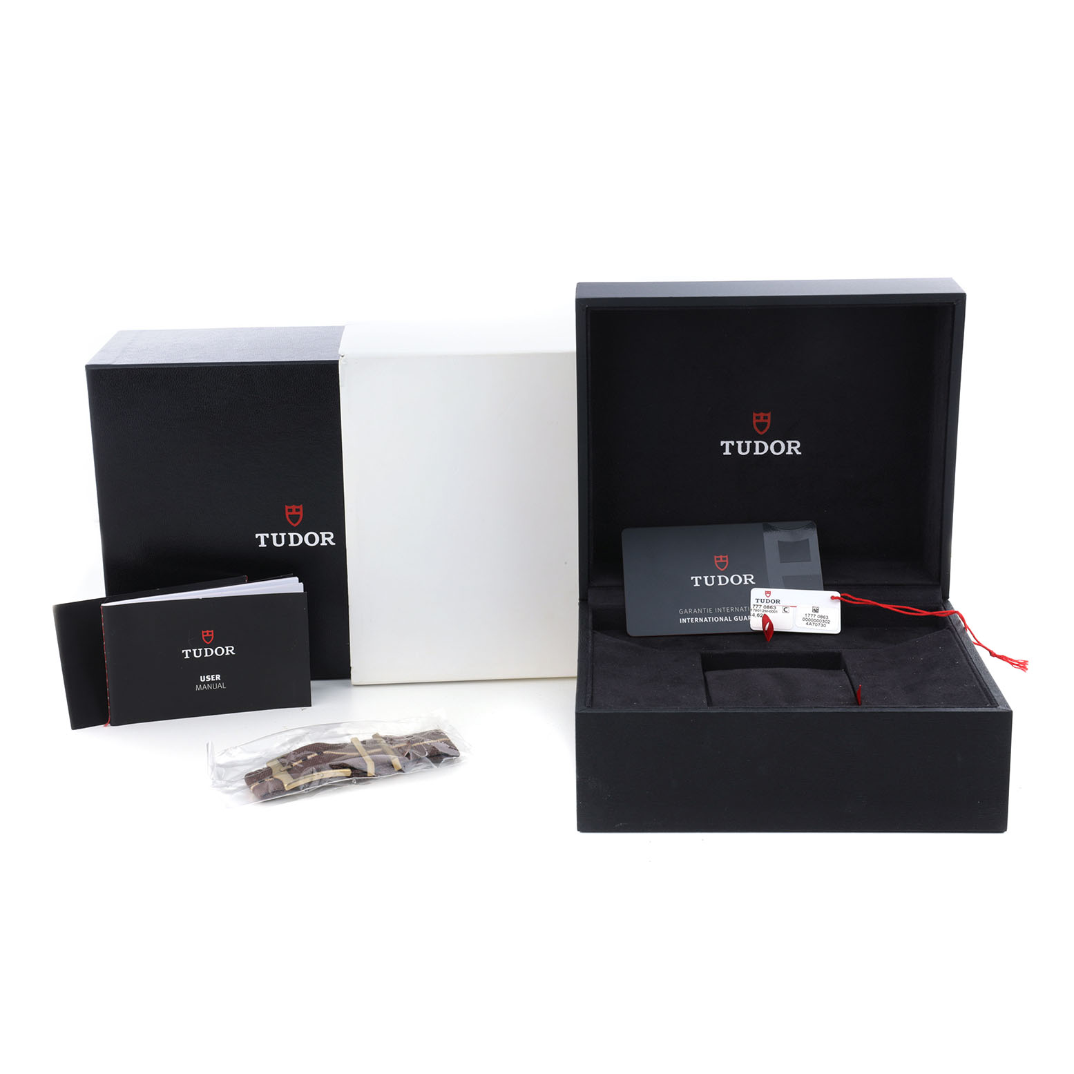 The Tudor Heritage Black Bay M79012M-0001 Men's Bronze Brown Dial accessories include a presentation box, warranty card, user manual, and extra strap from a frontal angle.