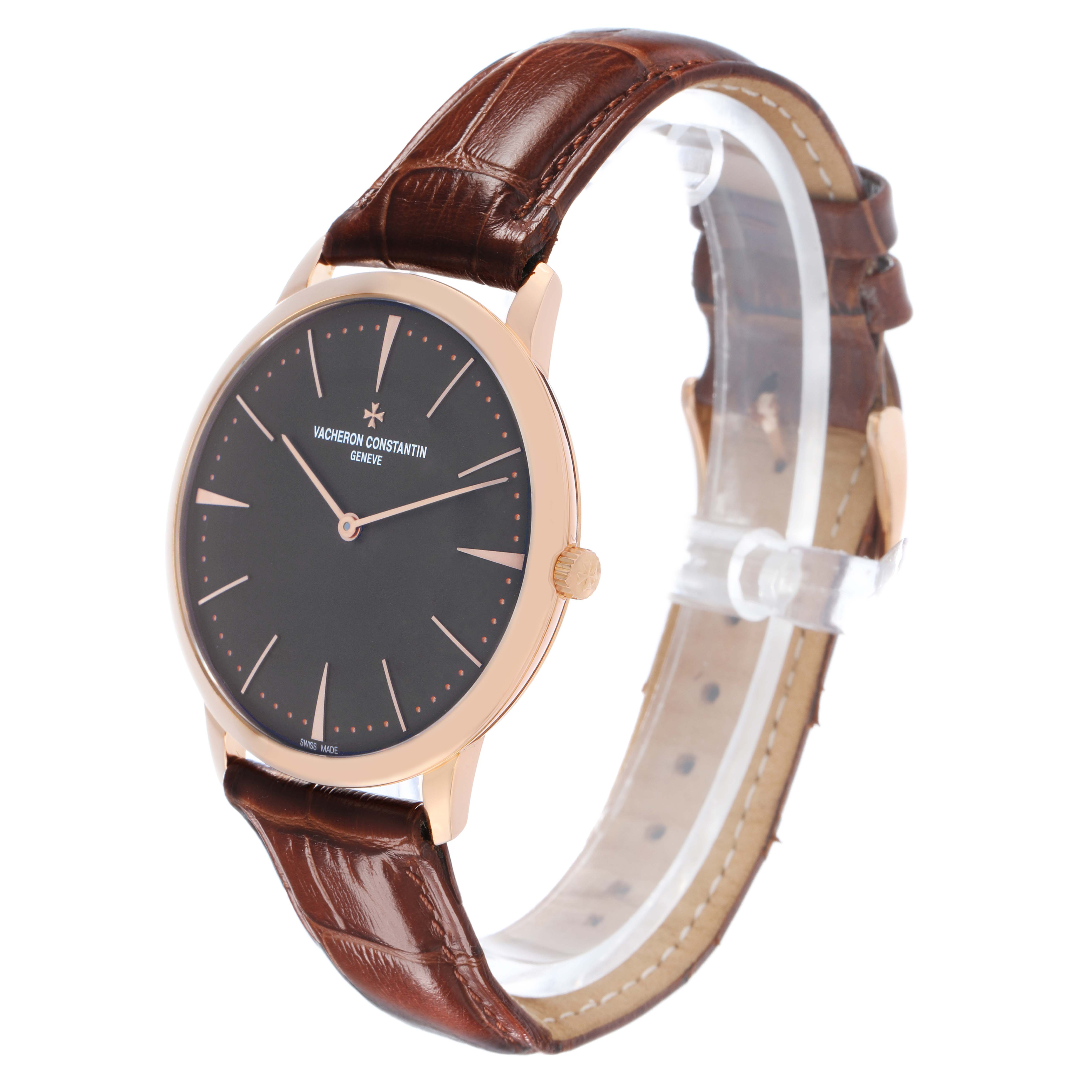 The Vacheron Constantin Patrimony 81180 Men
s Rose Gold Grey Dial watch is shown at a three-quarter angle, featuring its face and brown leather strap.