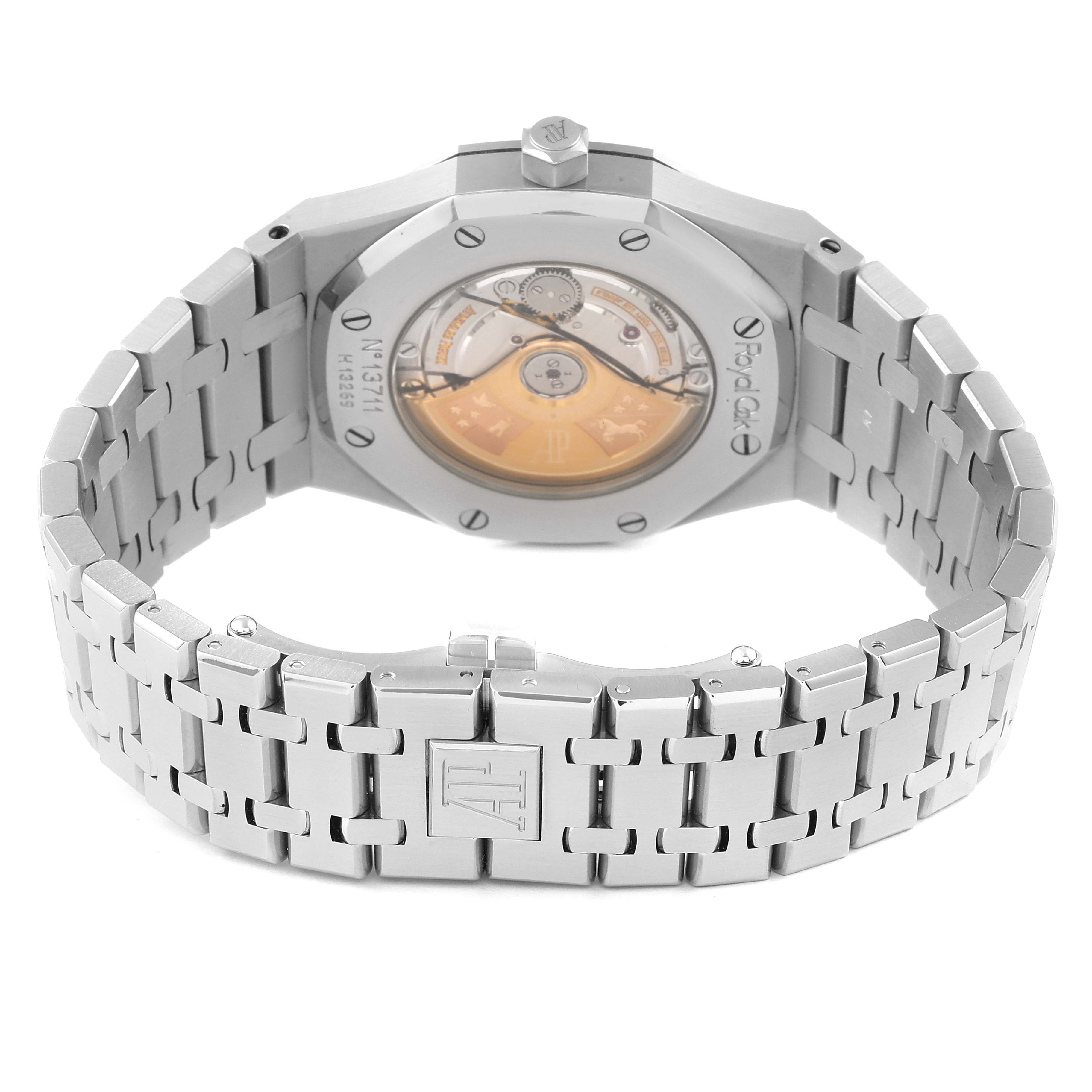 The image shows the back view of a Royal Oak model by Audemars Piguet, highlighting the see-through case back and stainless steel bracelet.
