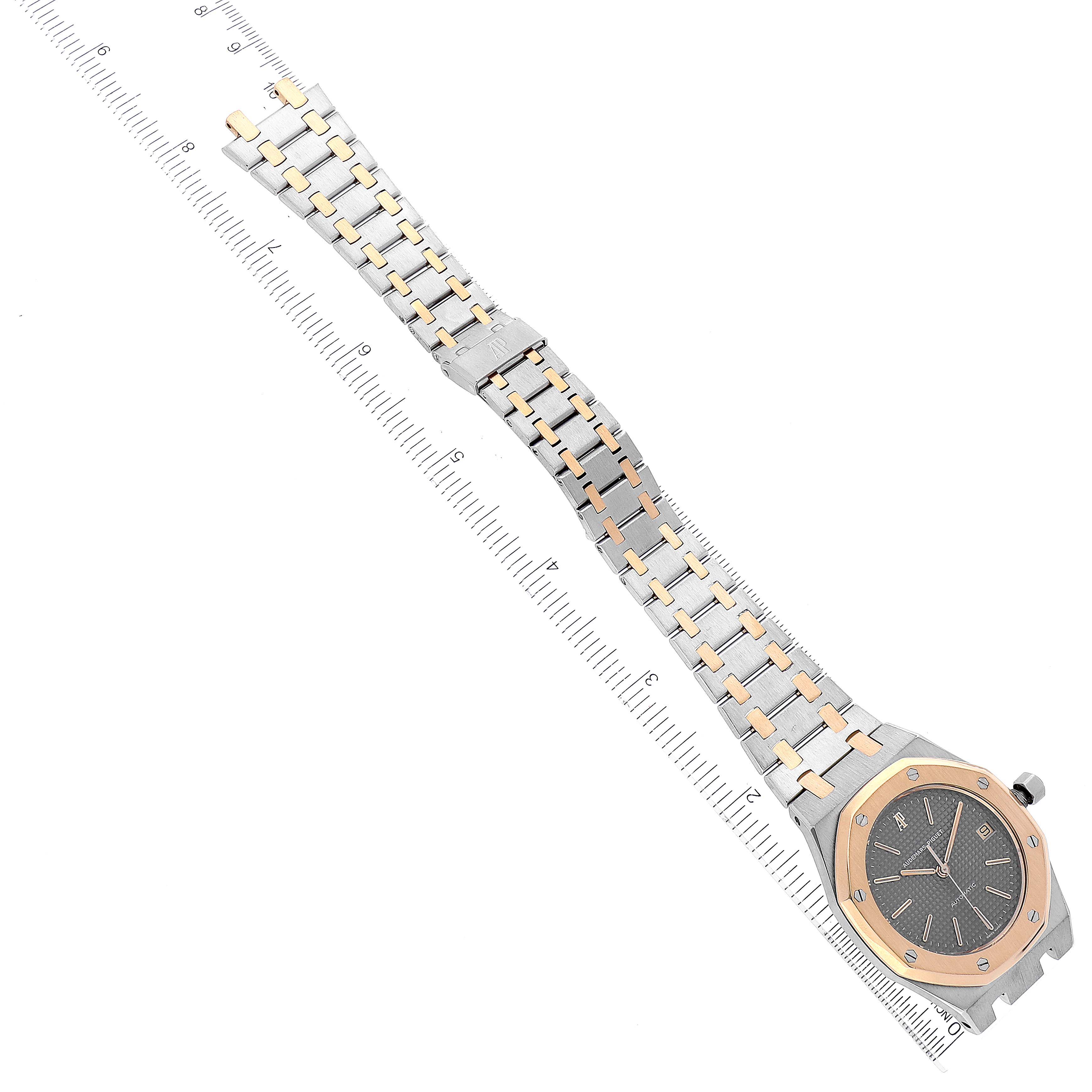 The image shows a top-down view of the Audemars Piguet Royal Oak 14100SA Men's Steel and Gold (two tone) Grey Dial 14100SA Men's Steel and Gold (two tone) Grey Dial watch, featuring its case and bracelet.