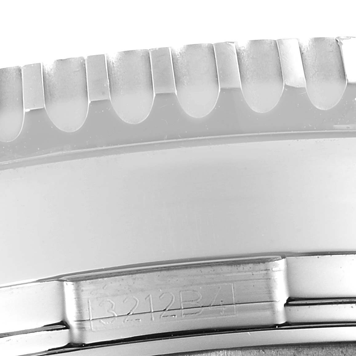 This close-up image of the Navitimer model by Breitling focuses on the detail of the bezel and case side with visible engravings.