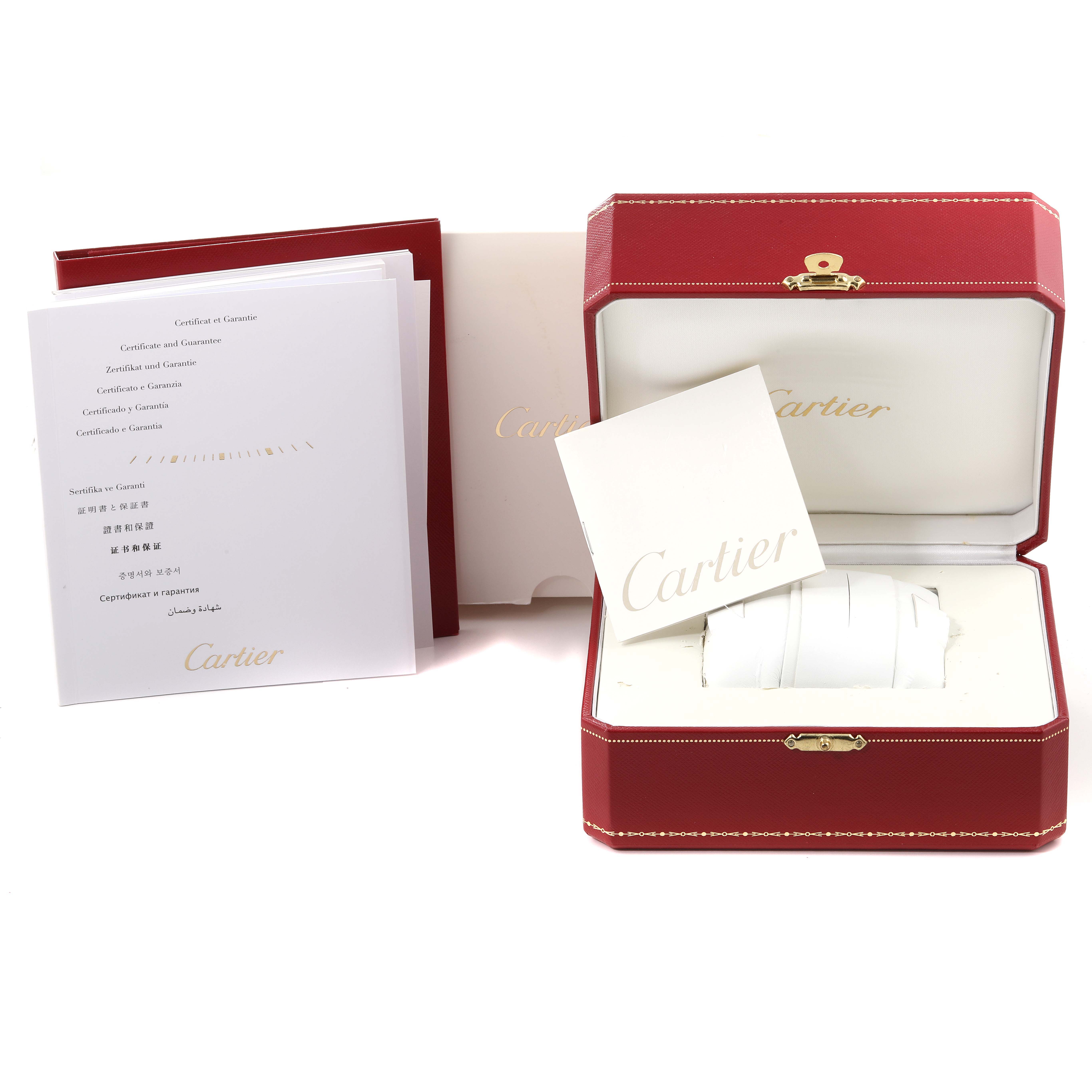 The image shows the packaging, warranty papers, and presentation box for the Ballon Bleu model by Cartier.