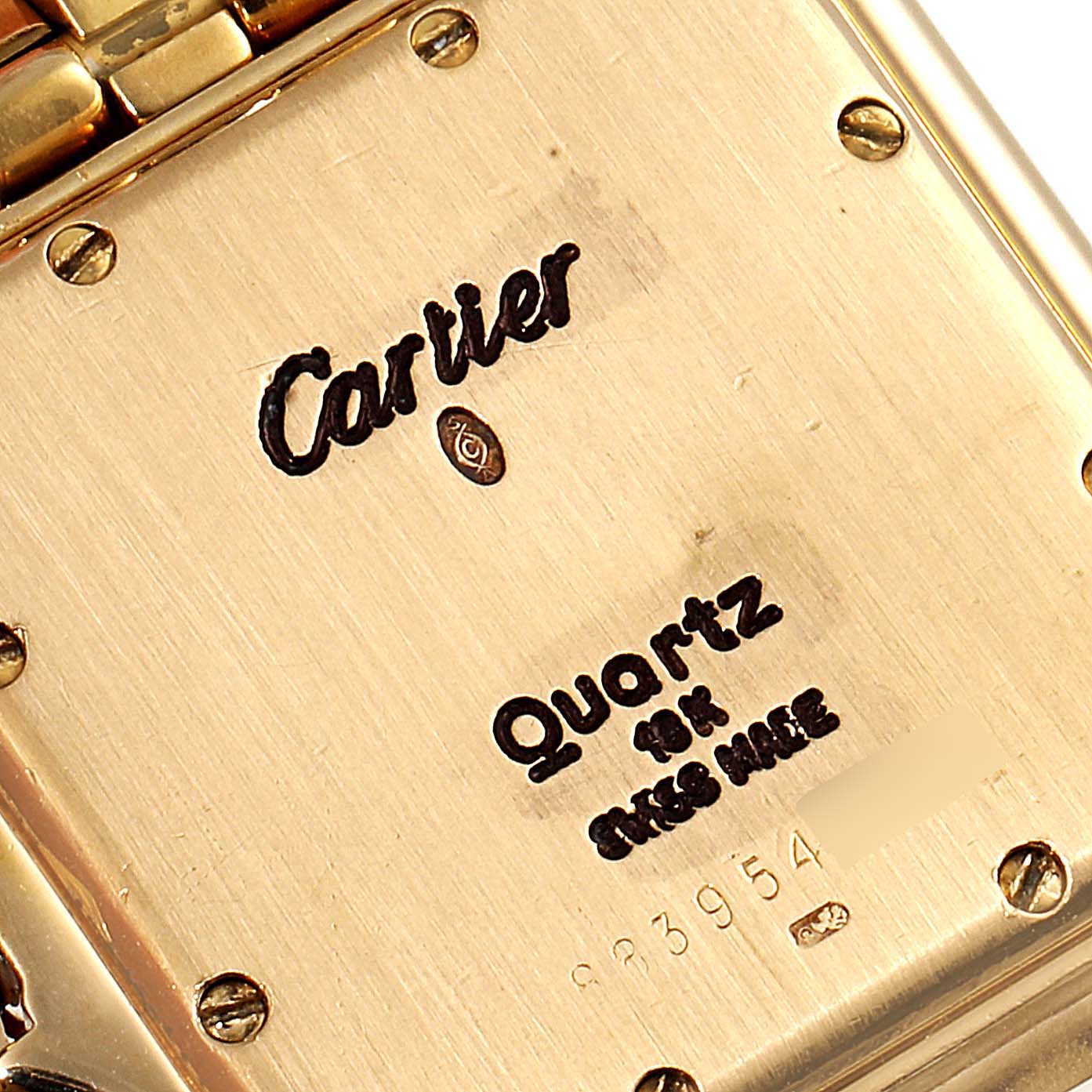 This image shows the back of the Panthere model watch by Cartier with inscriptions and screws visible.