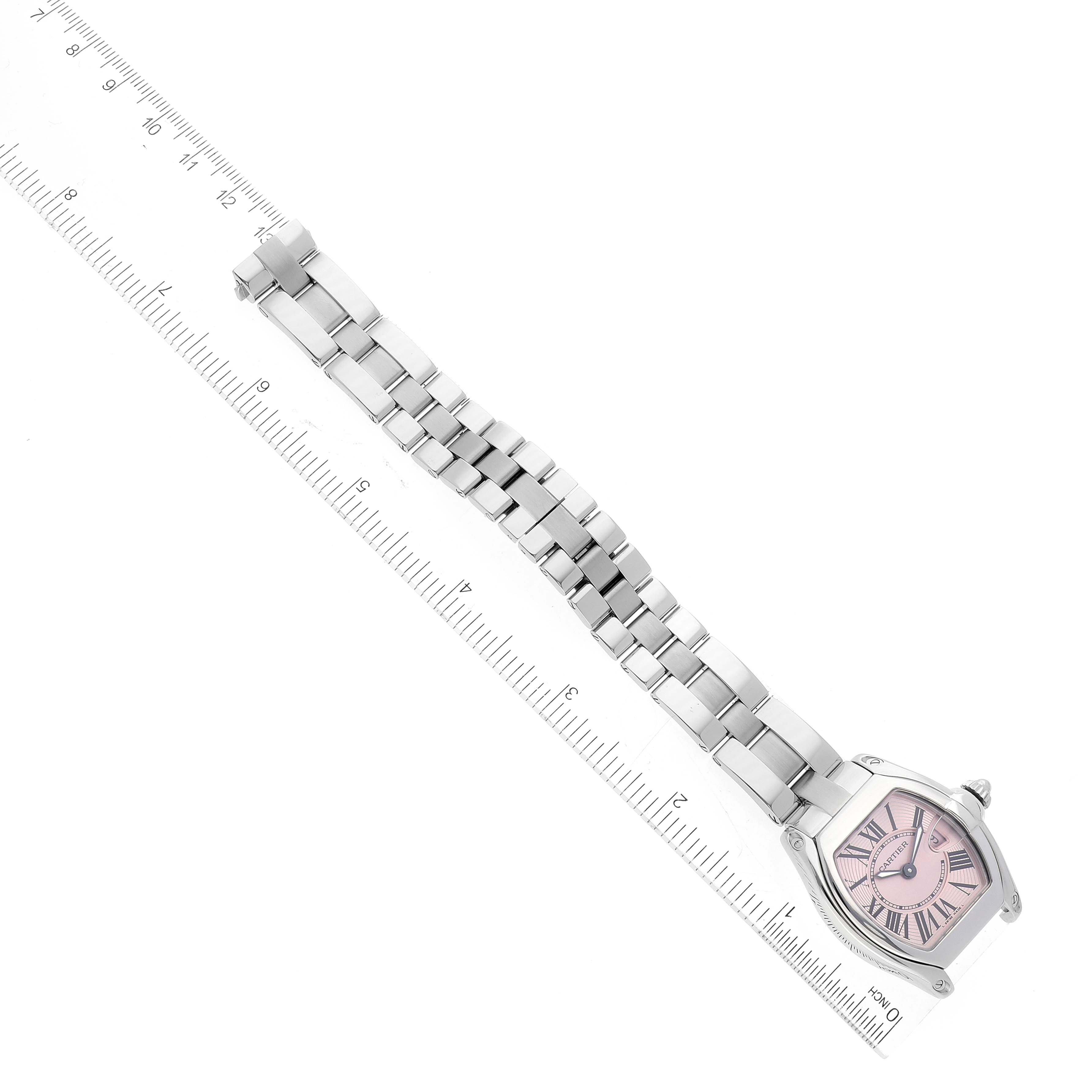 The image shows a Cartier Roadster W62017V3 Women's Stainless Steel Pink Dial W62017V3 Women's Stainless Steel Pink Dial watch displayed flat with its bracelet fully extended alongside a ruler for measurement.